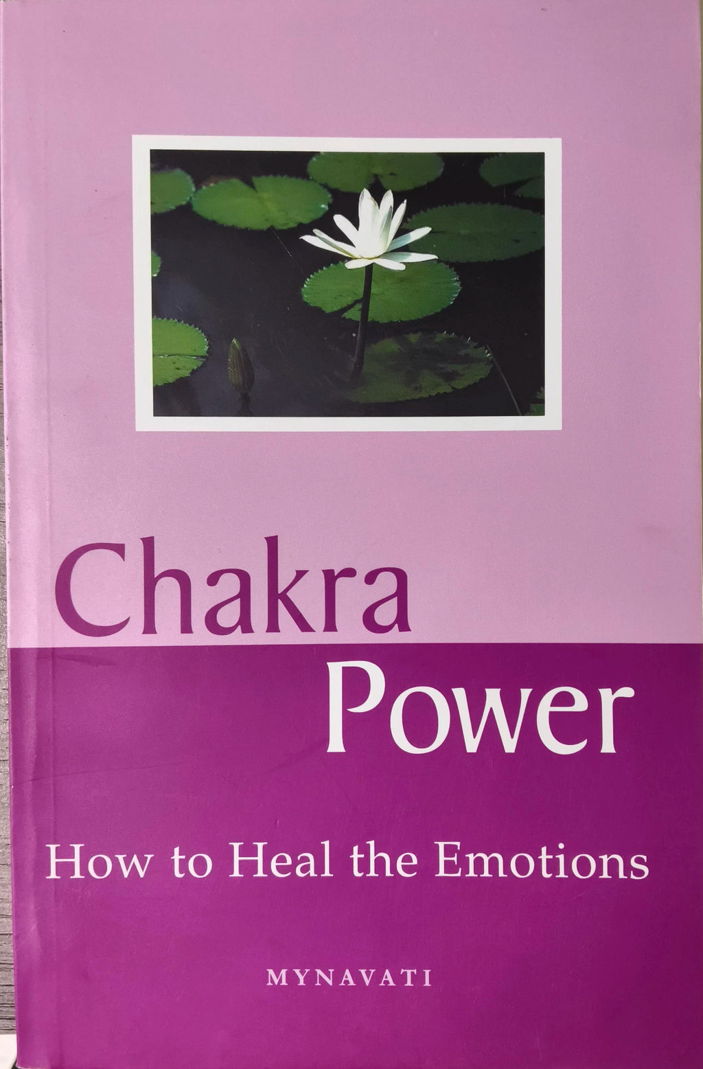 Paperback book titled Chakra Power by Mynavati with white lotus on cover