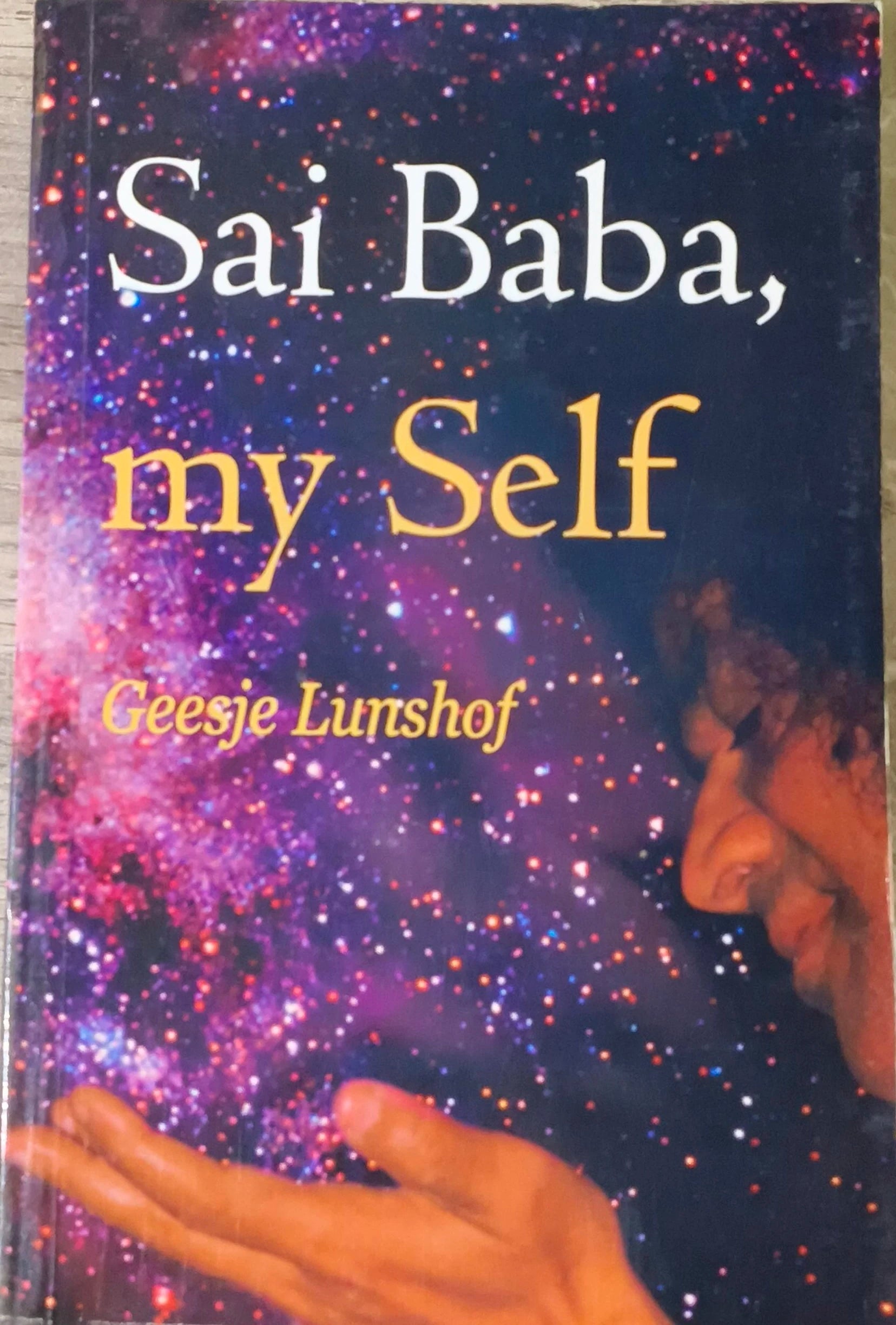 Paperback book titled Sai Baba, my Self by Geesje Lunshof with cosmic background