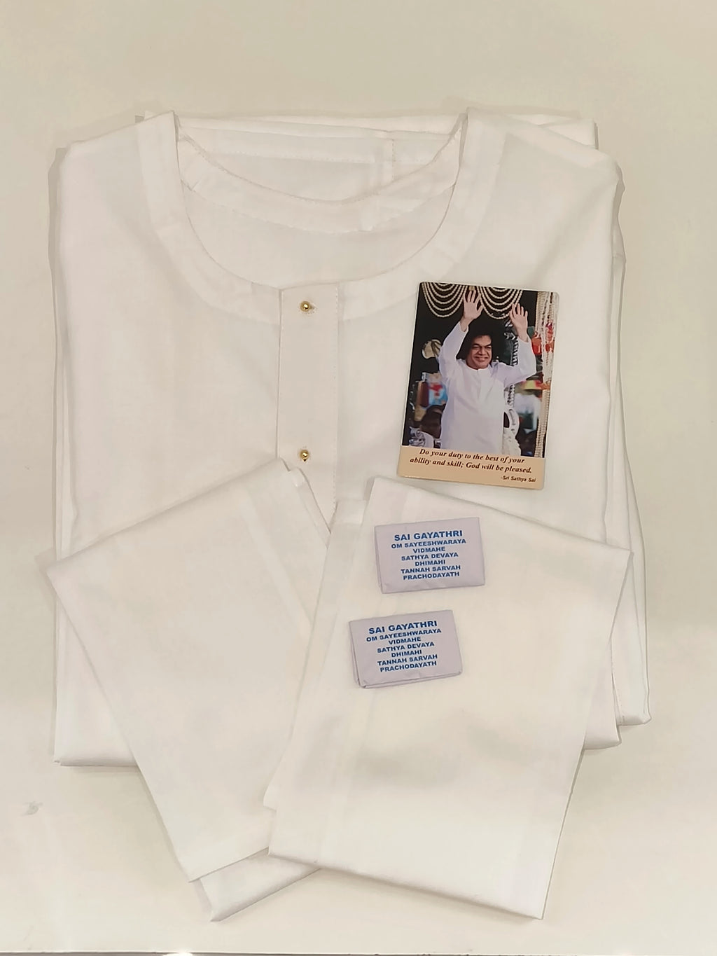 Folded white Swamy robe with two matching napkins and devotional cards