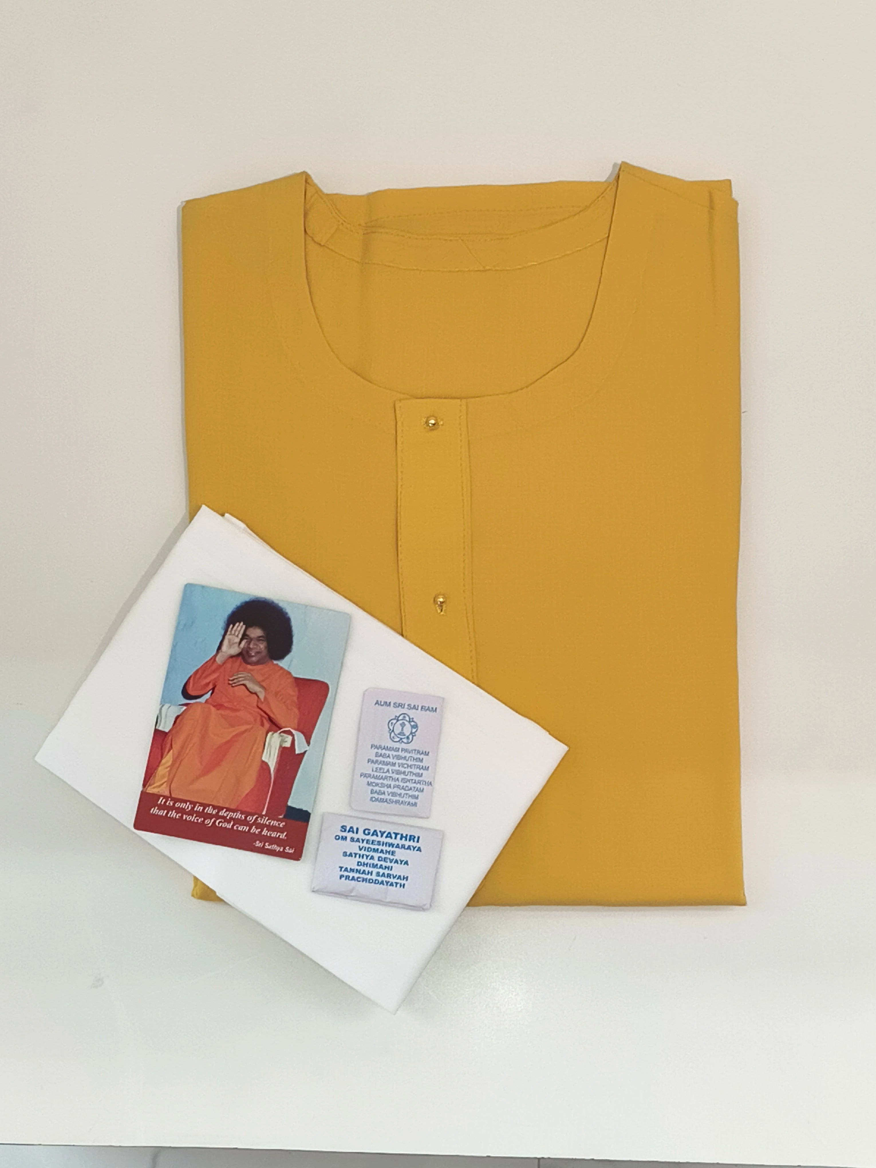 Yellow Swamy robe folded with white napkins and packets of vibhuthi