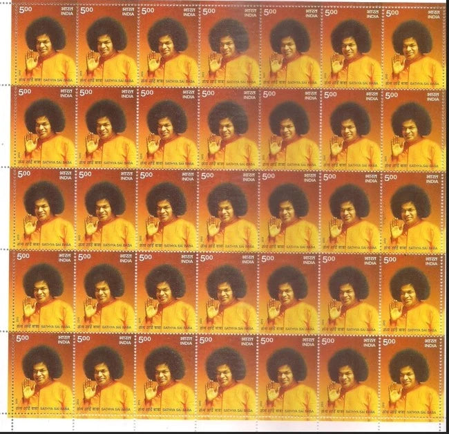 Full sheet of commemorative Sai Baba postage stamps with orange background