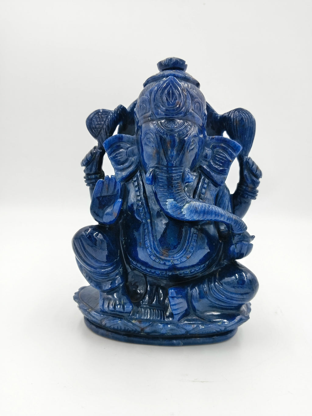 Blue jade statue of Hindu deity Ganesh sitting and holding symbolic objects