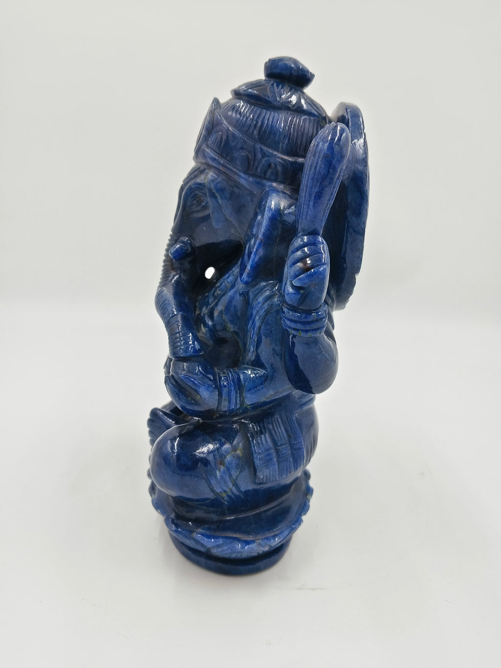 Blue jade sculpture of Indian deity Ganesh in seated posture, side view
