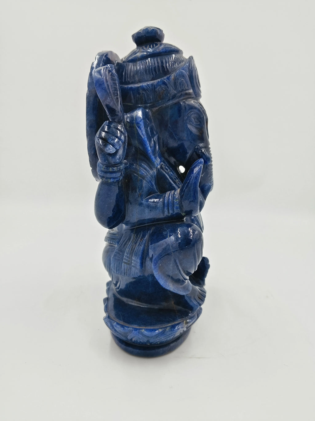 Blue jade sculpture of seated Hindu deity Ganesh with detailed carvings