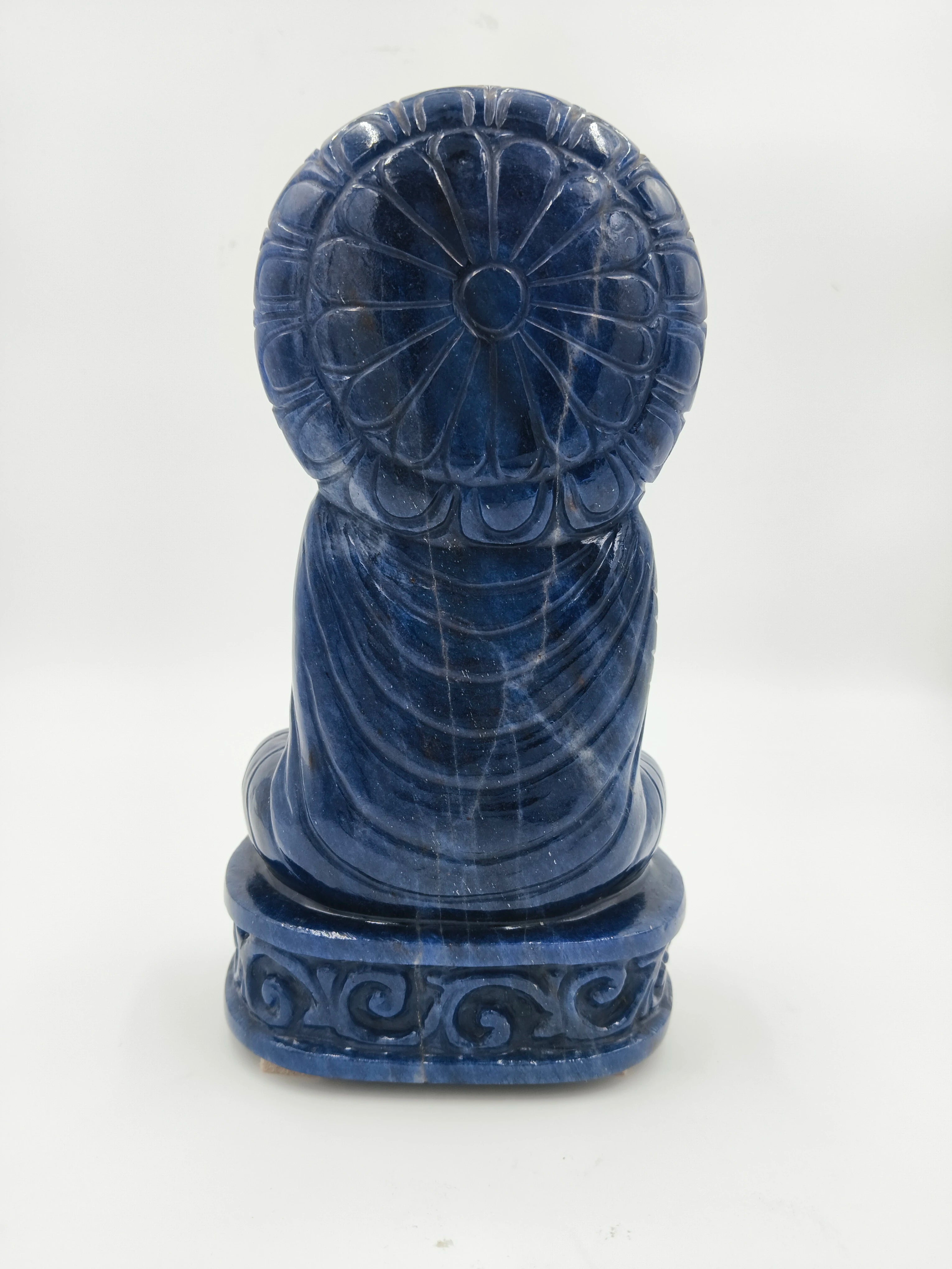 Back view of blue jade Buddha statue with decorative base and halo
