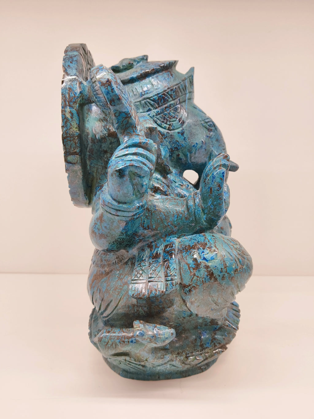 Side view of large Chrysocolla Ganesh sculpture with intricate detailing