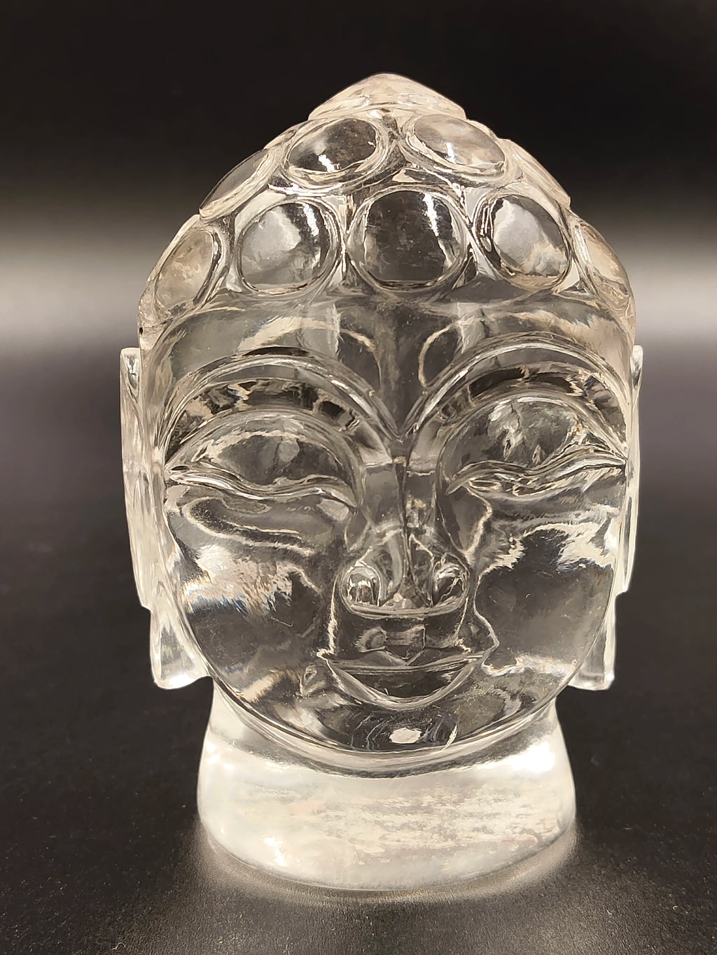 Crystal Buddha head idol sculpture with detailed facial features, front view