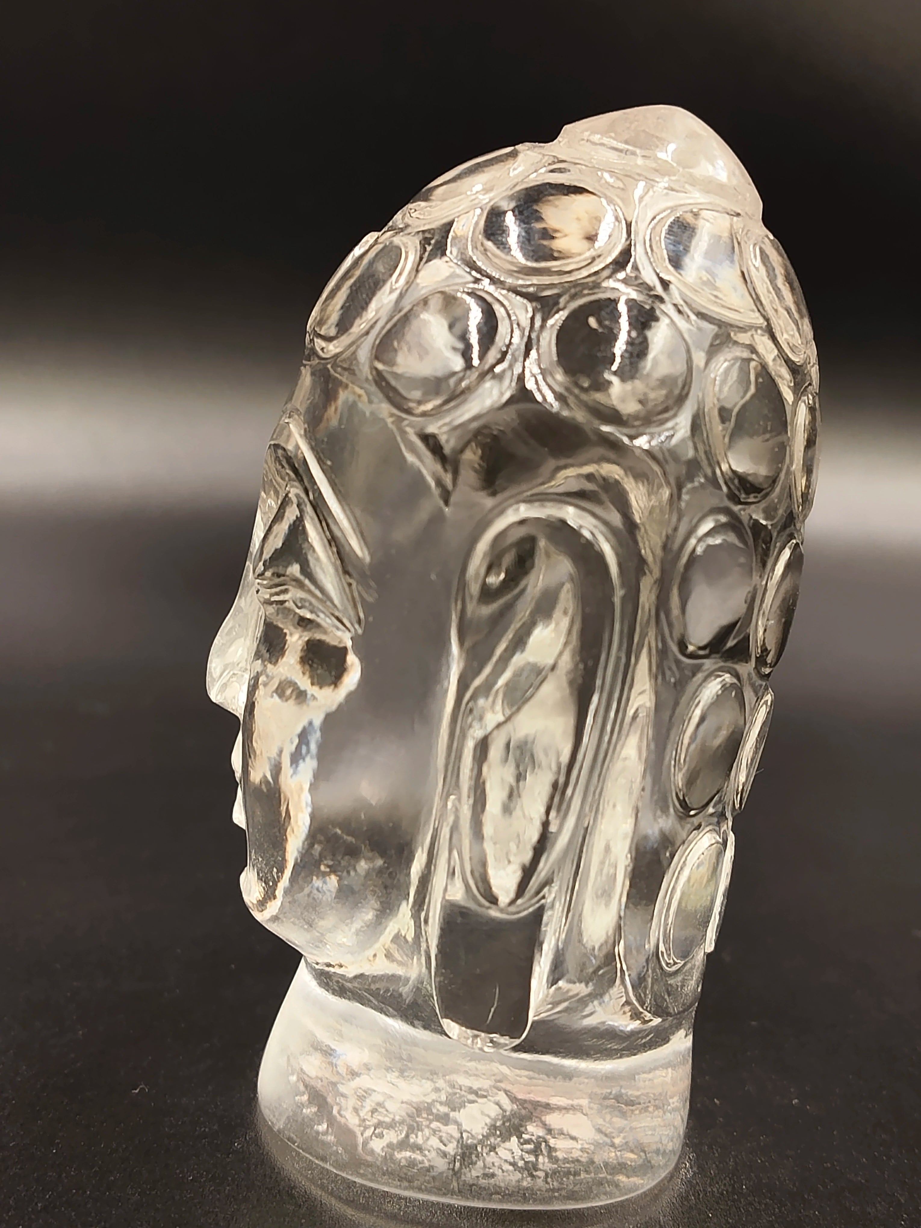Side view of crystal Buddha head idol sculpture with intricate details