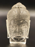 Clear crystal sculpture of Buddha head with detailed textured hair