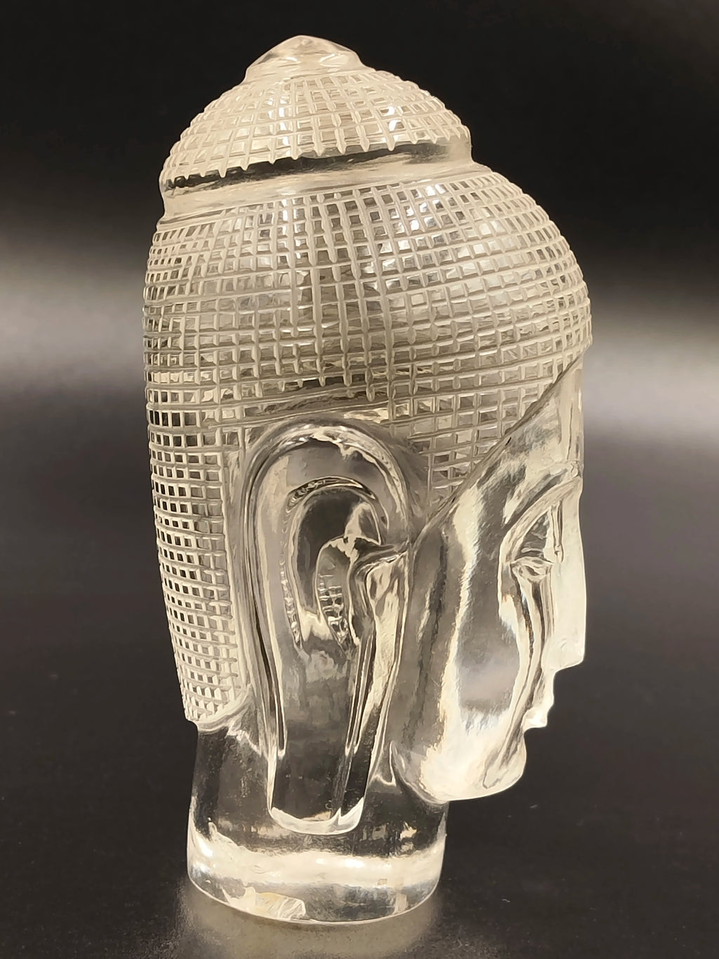 Crystal Buddha head sculpture with detailed carved hair and facial features