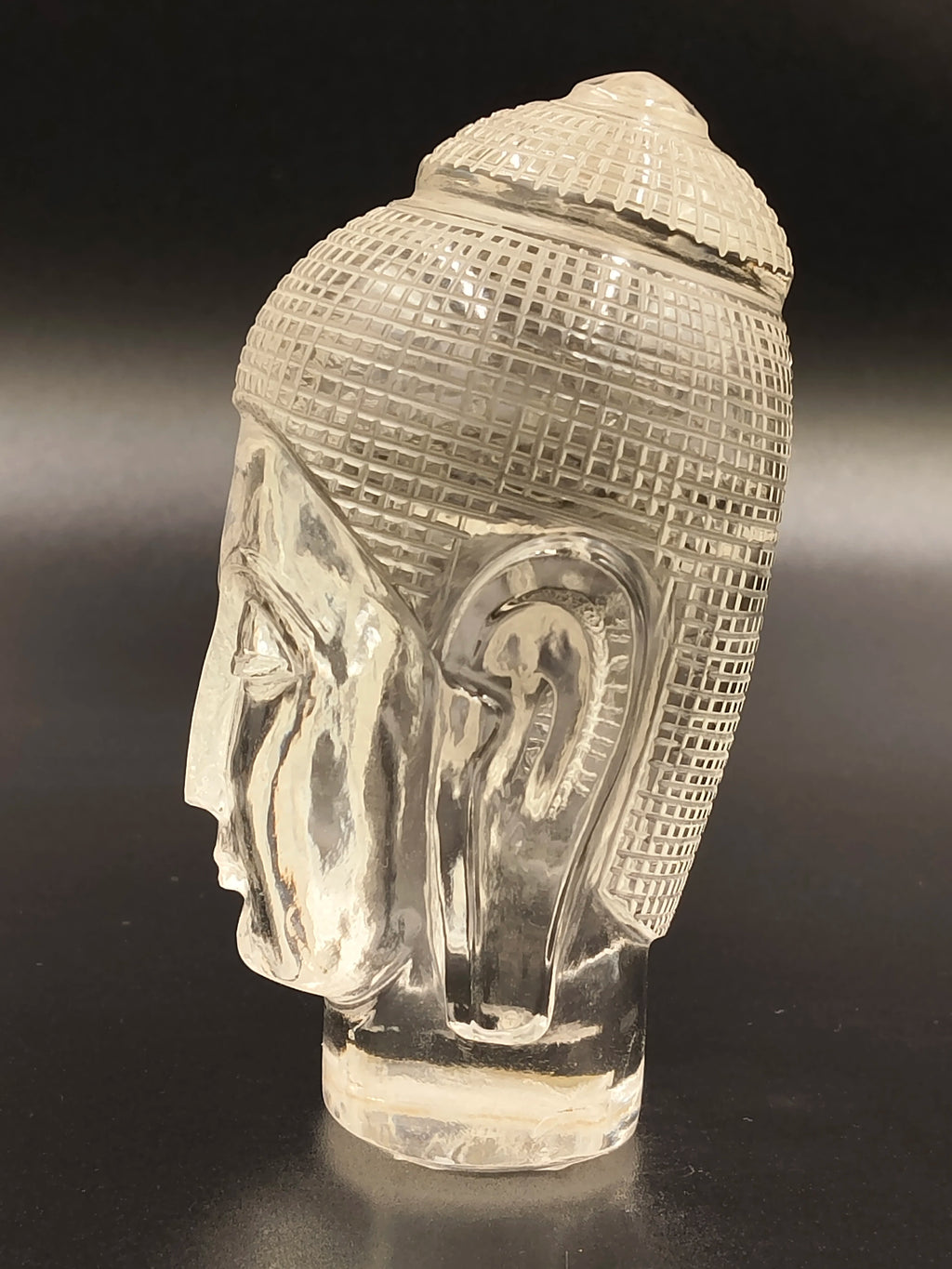 Clear crystal sculpture of Buddha head side view, small tabletop decor