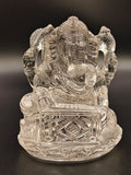 Clear crystal sculpture of Hindu deity Ganesh playing a musical instrument