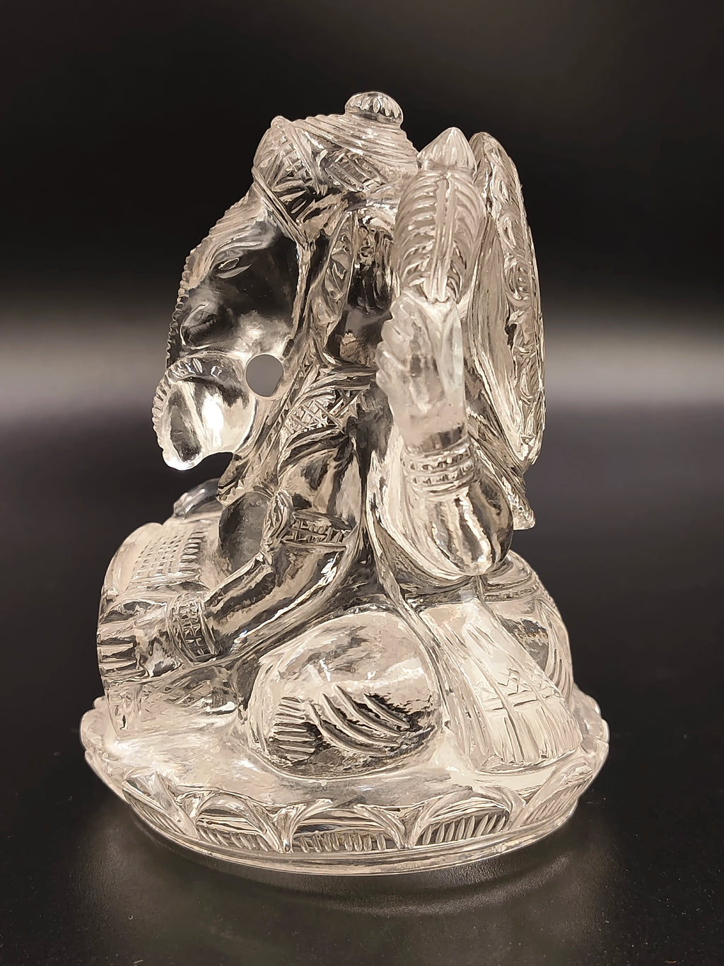 Clear crystal Ganesh figurine with detailed carvings on side view