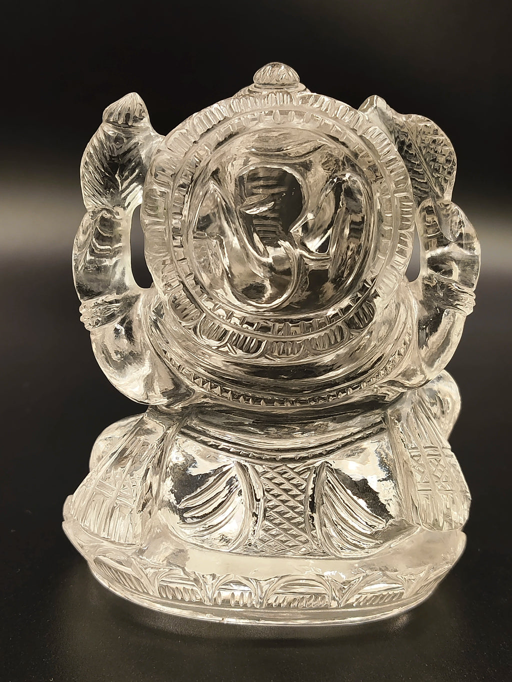 Small crystal Ganesh figurine with intricate carved details, front view