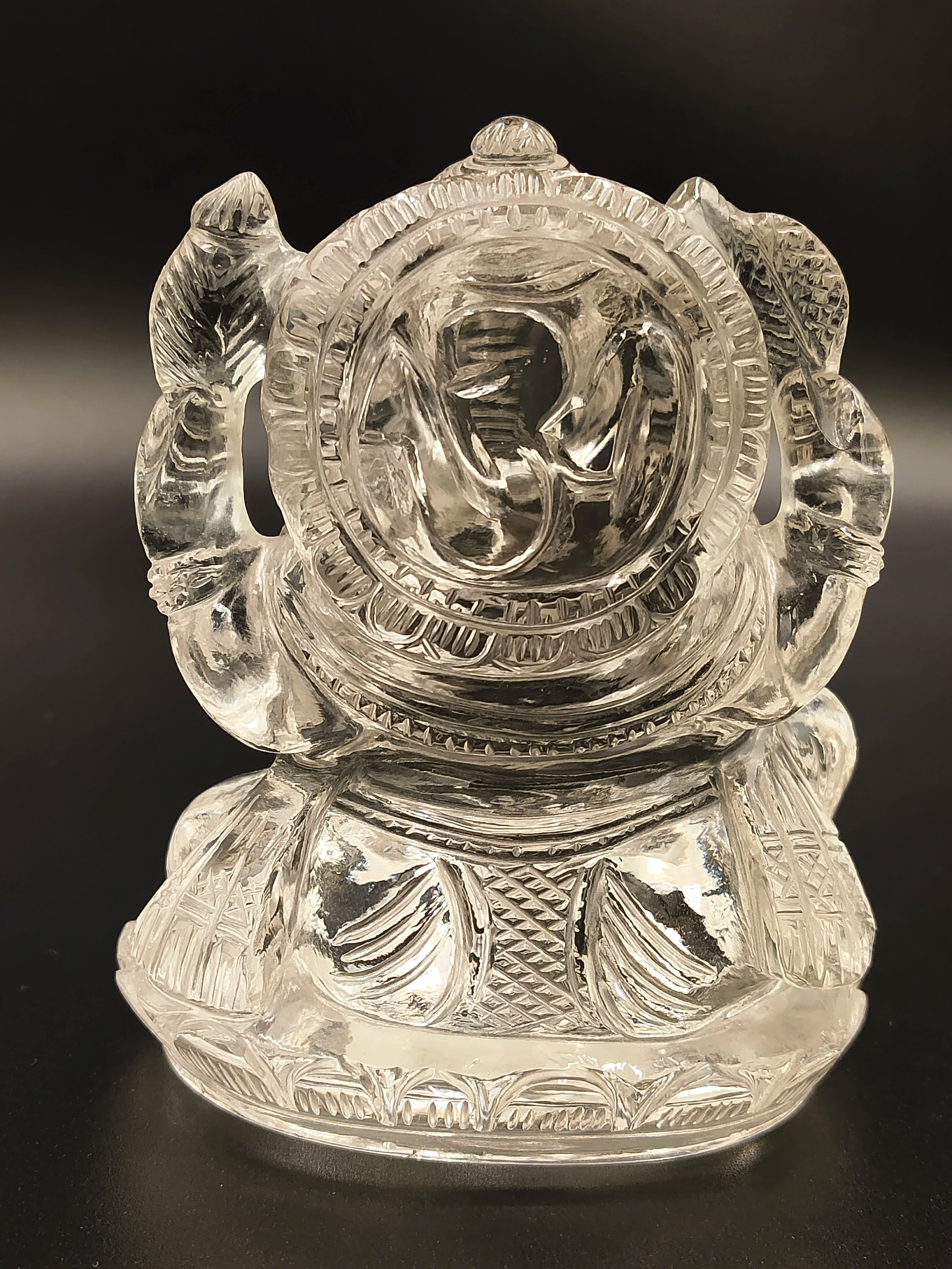 Small crystal Ganesh figurine with intricate carved details, front view