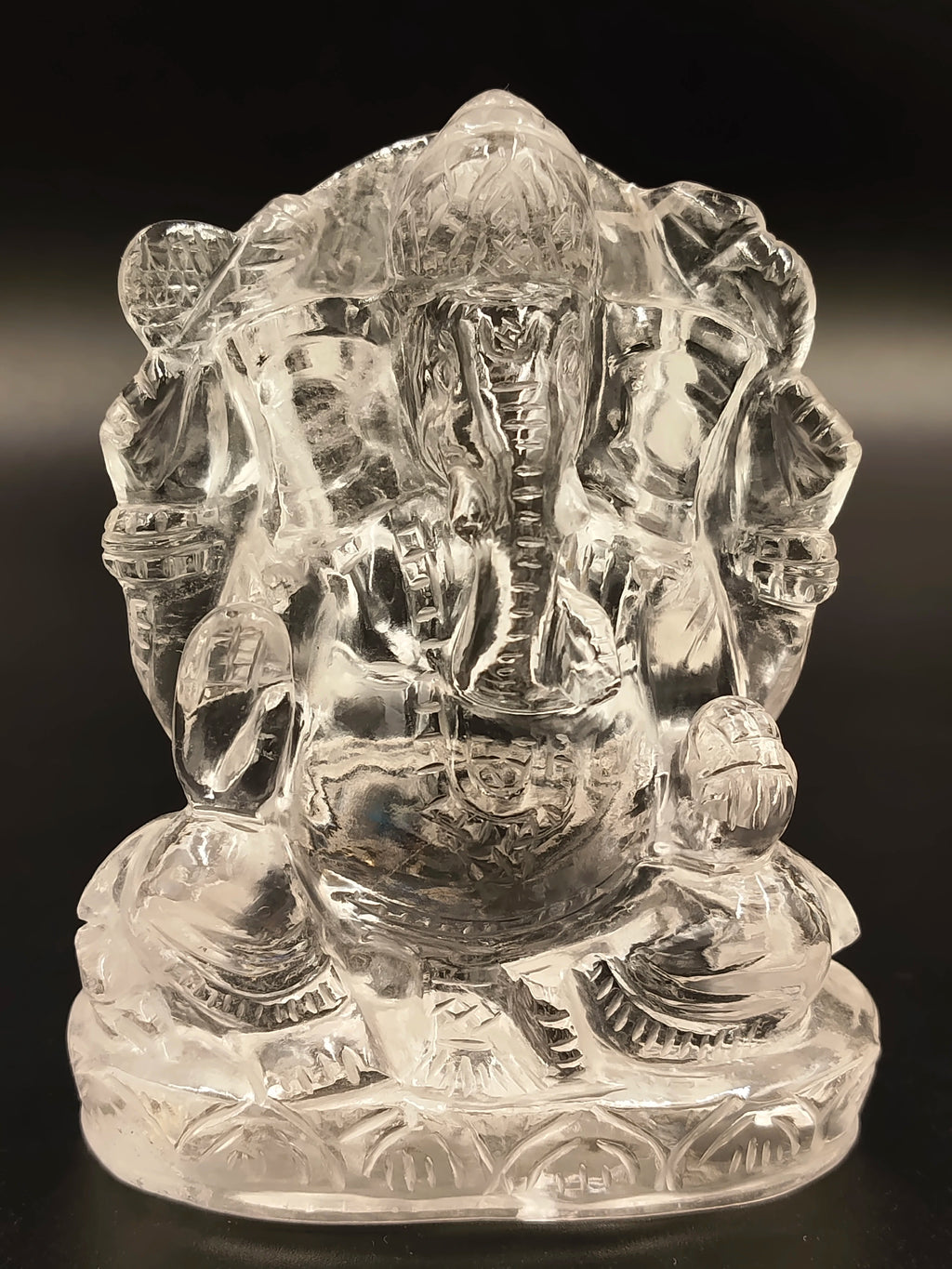 Small crystal sculpture of Hindu deity Ganesh sitting cross-legged