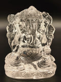 Small crystal sculpture of Hindu deity Ganesh sitting cross-legged