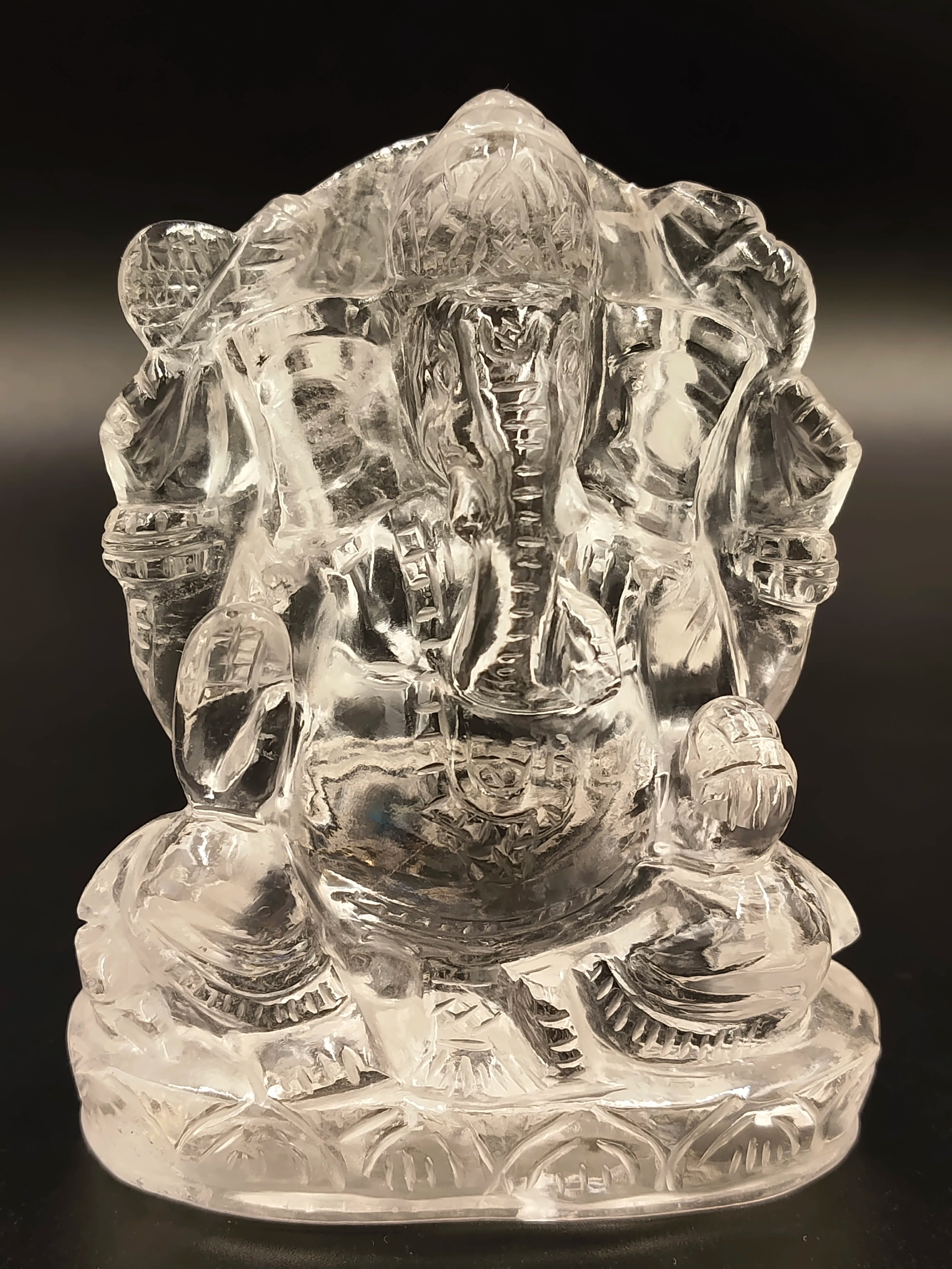 Small crystal sculpture of Hindu deity Ganesh sitting cross-legged
