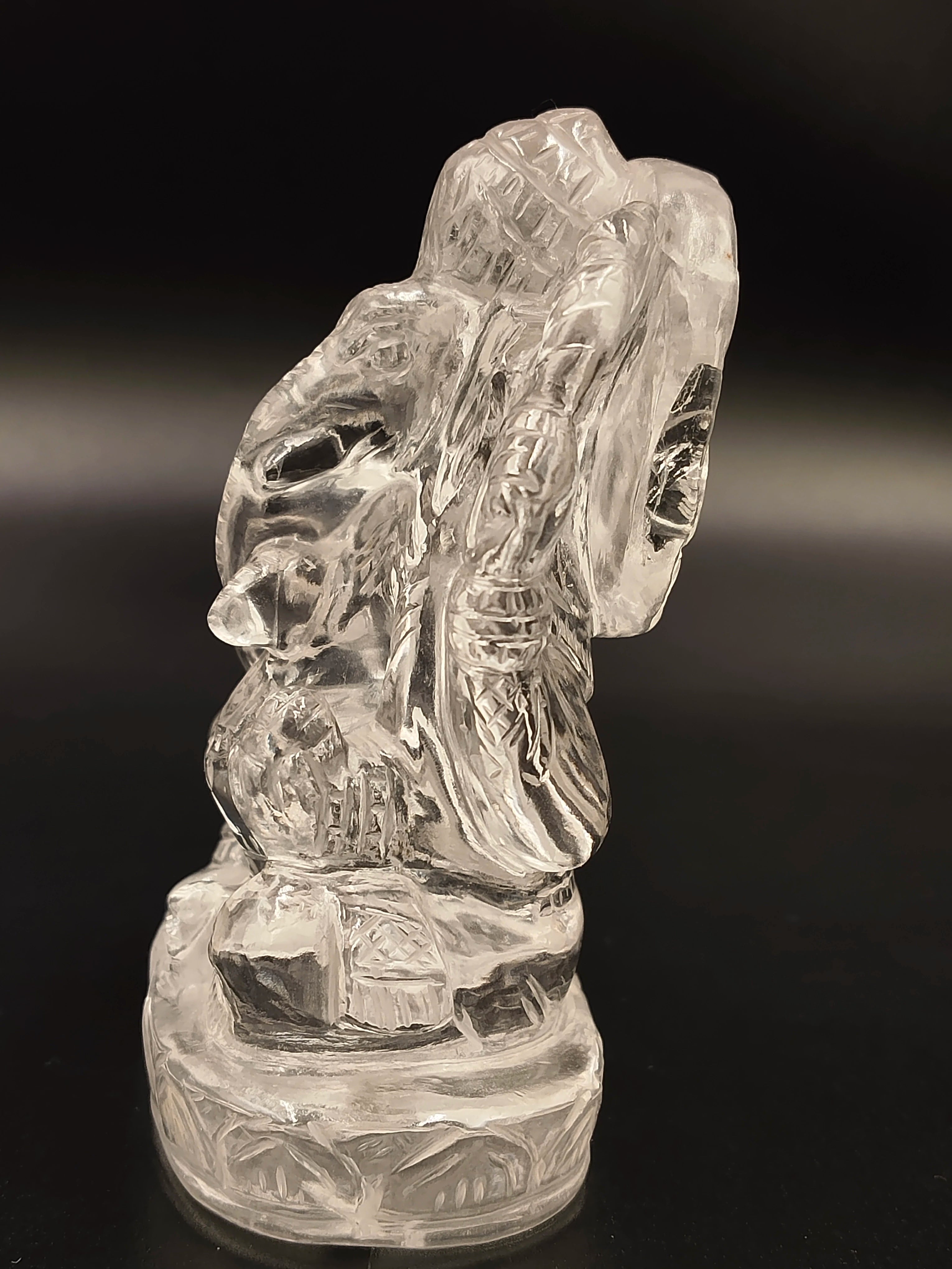 Crystal sculpture of Ganesh deity on a round base with detailed engravings