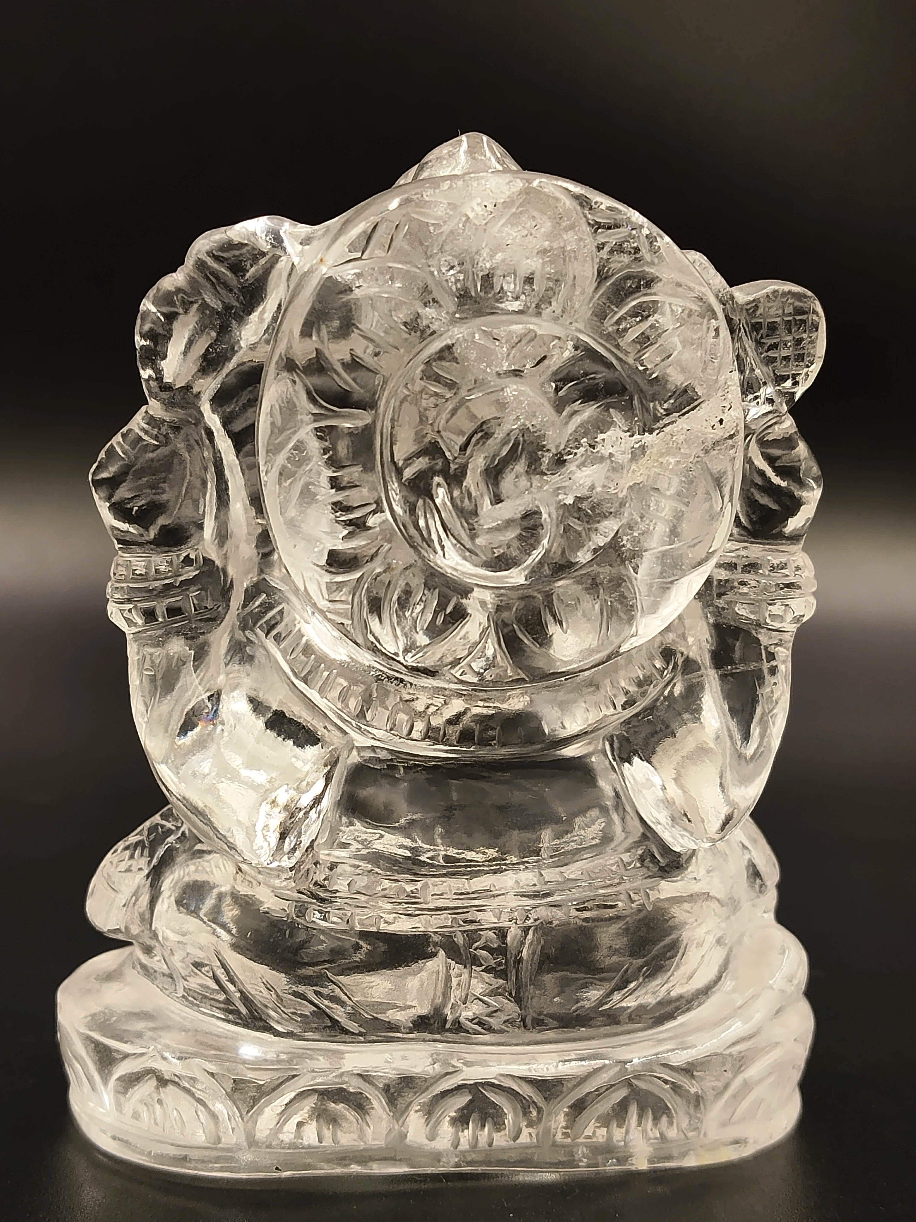 Small crystal sculpture of Hindu deity Ganesh seated on engraved base