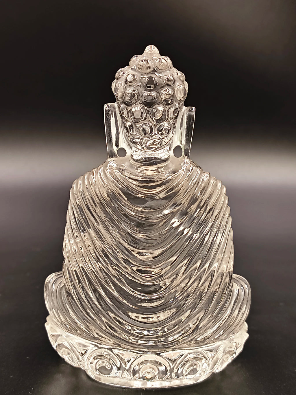 Back view of a 3.5 inch clear crystal Buddha sculpture with detailed robes
