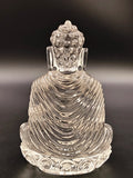 Back view of a 3.5 inch clear crystal Buddha sculpture with detailed robes