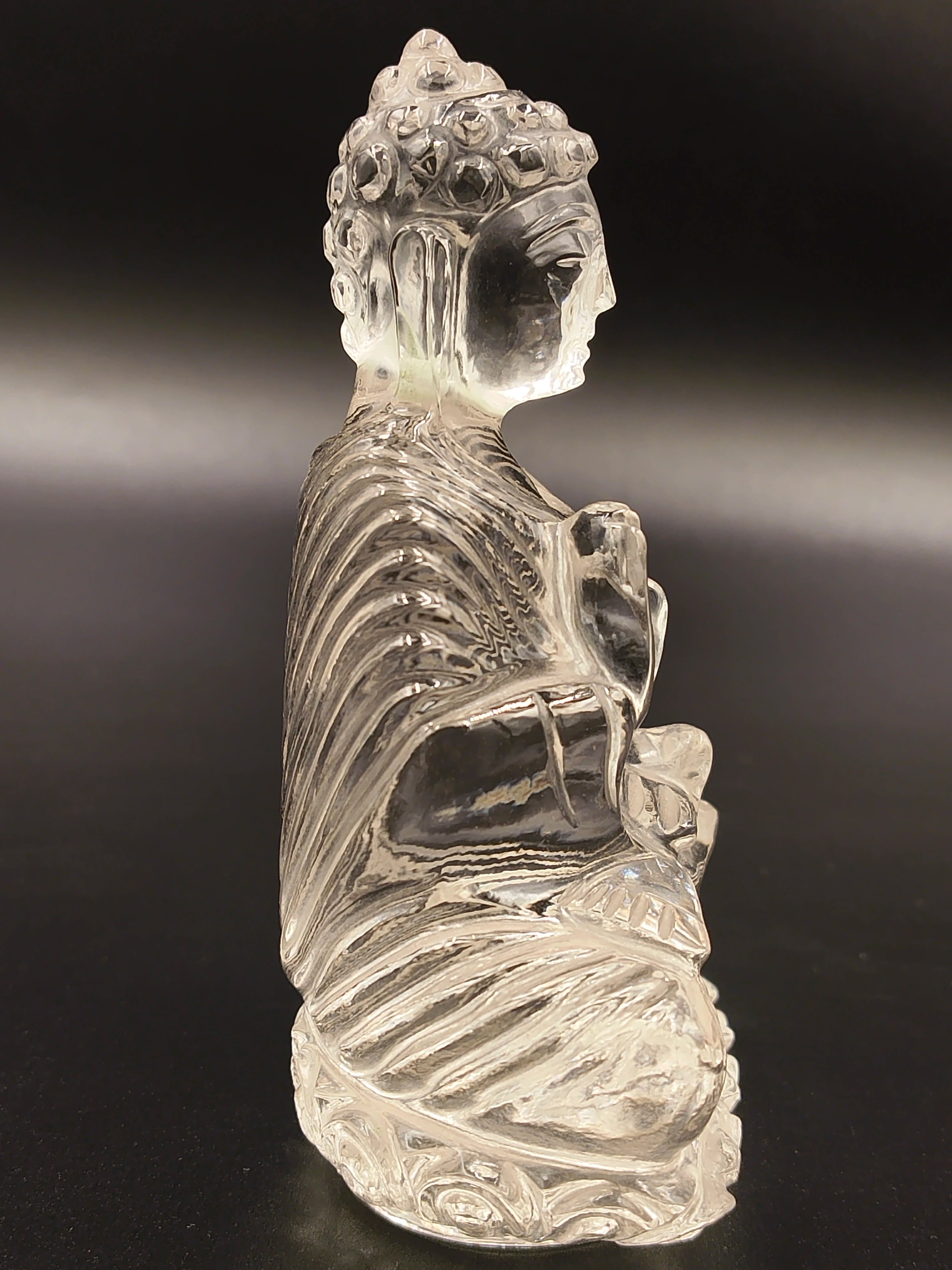 Side view of small 3.5-inch transparent crystal Buddha statue seated