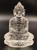Clear crystal Buddha figurine seated in meditation, front view