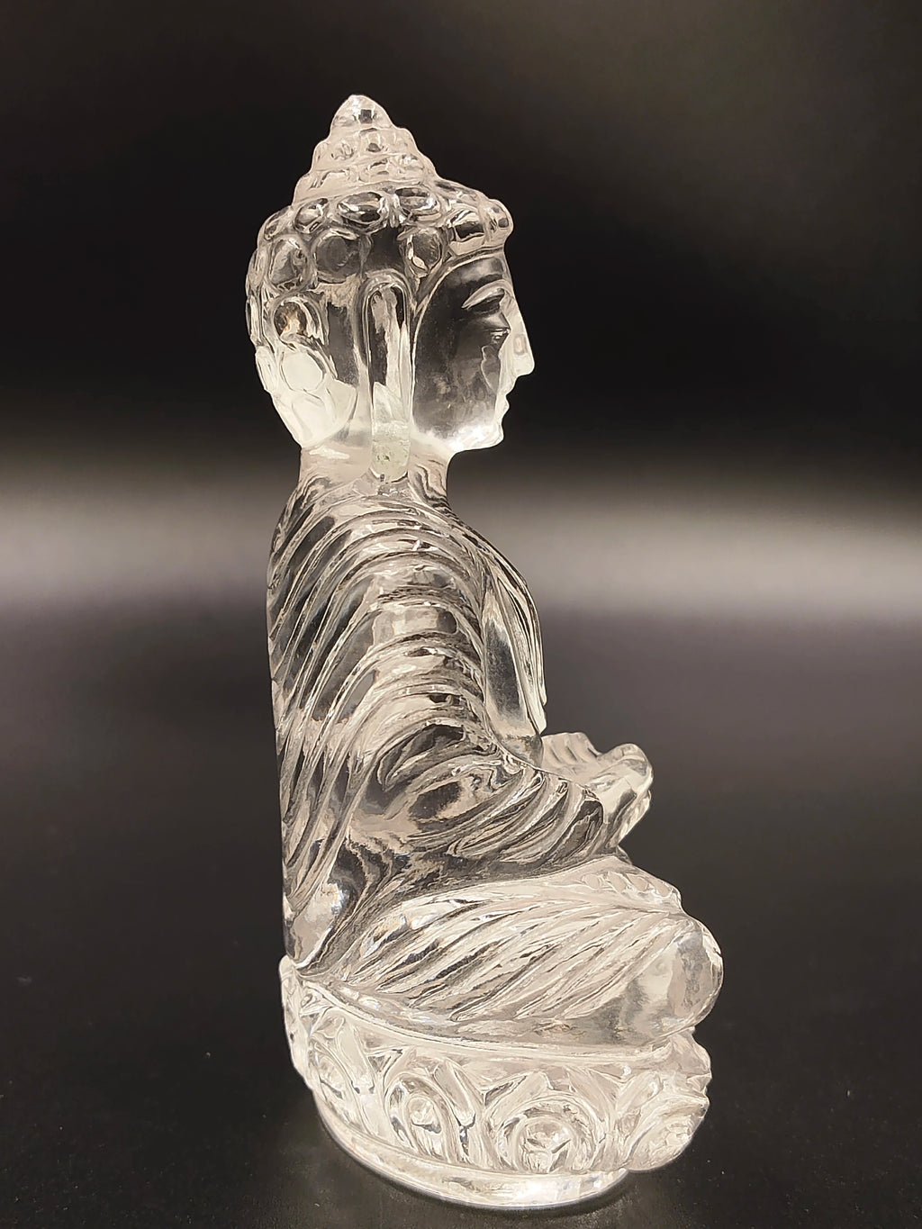 Side view of 3.6 inch transparent crystal Buddha sculpture seated in meditation