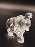 Clear crystal elephant figurine sculpture on a dark surface