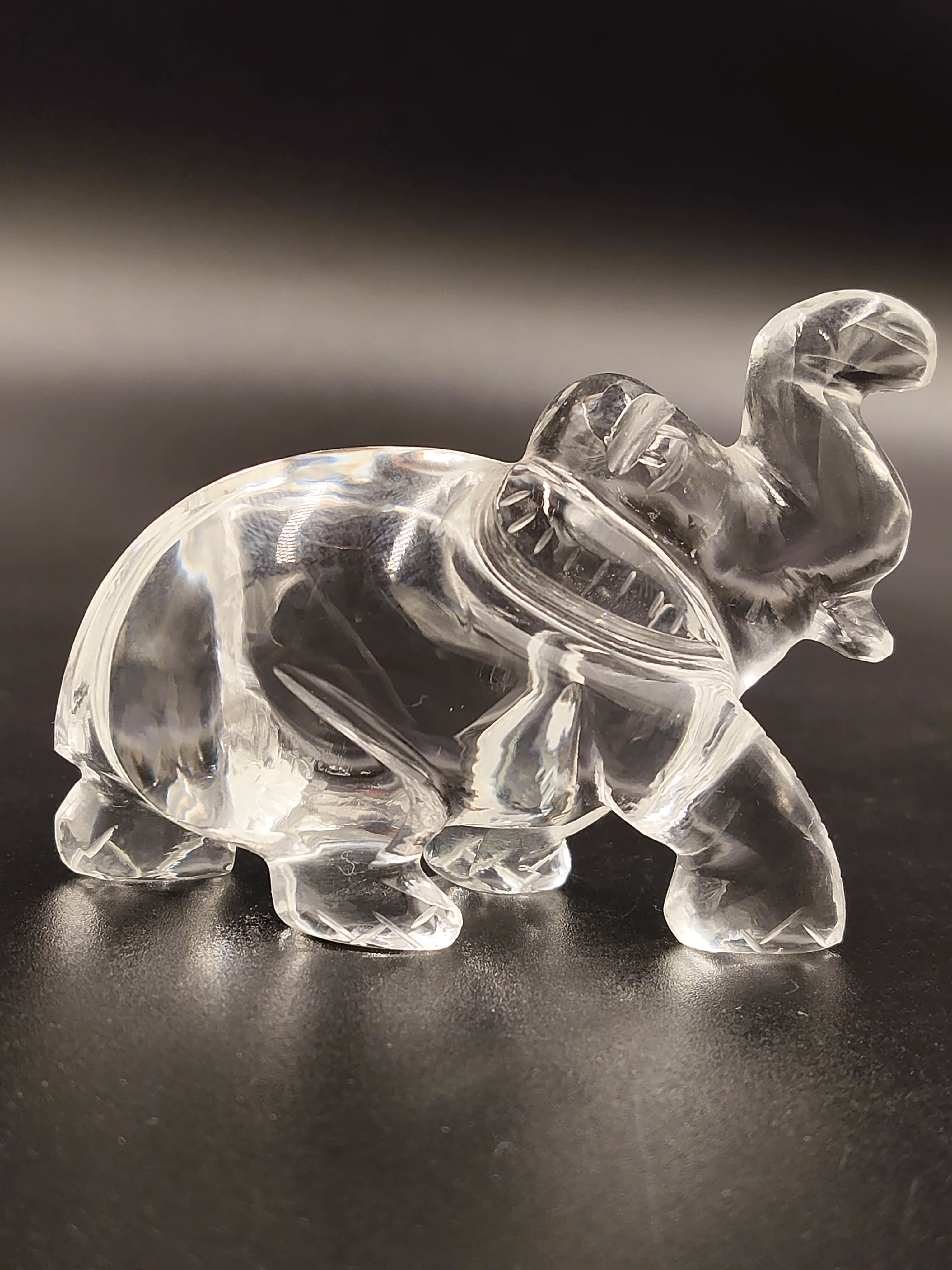 Clear crystal elephant figurine sculpture on black surface