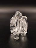 Clear crystal elephant figurine viewed from the back on black background