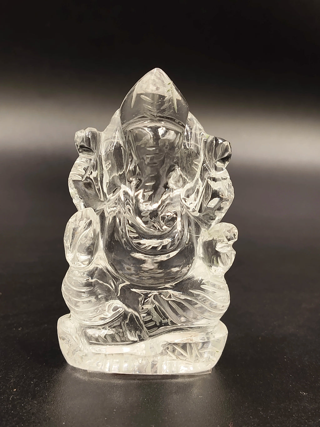 Mini clear crystal sculpture of Ganesh deity sitting with detailed carving