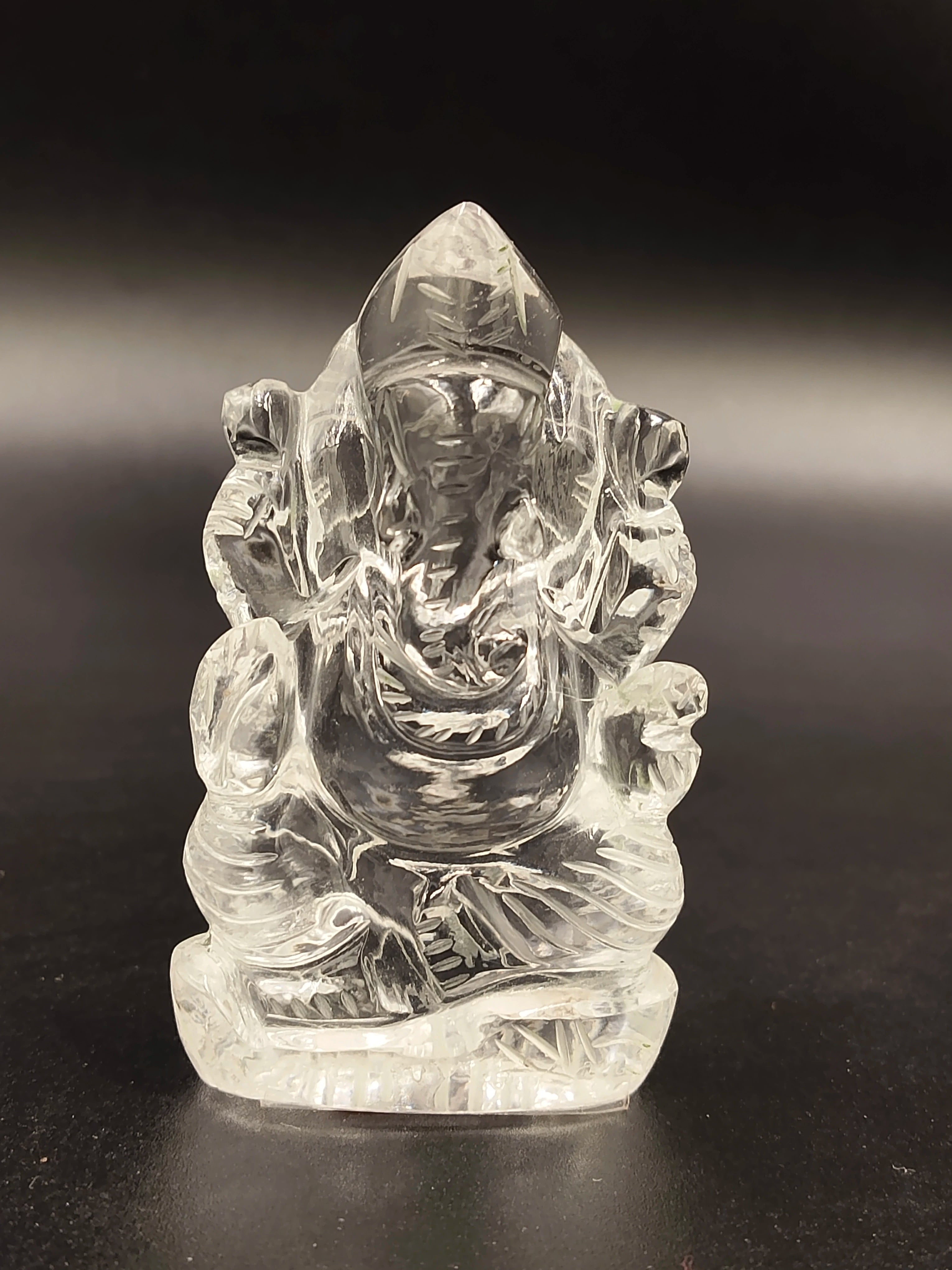 Mini clear crystal sculpture of Ganesh deity sitting with detailed carving