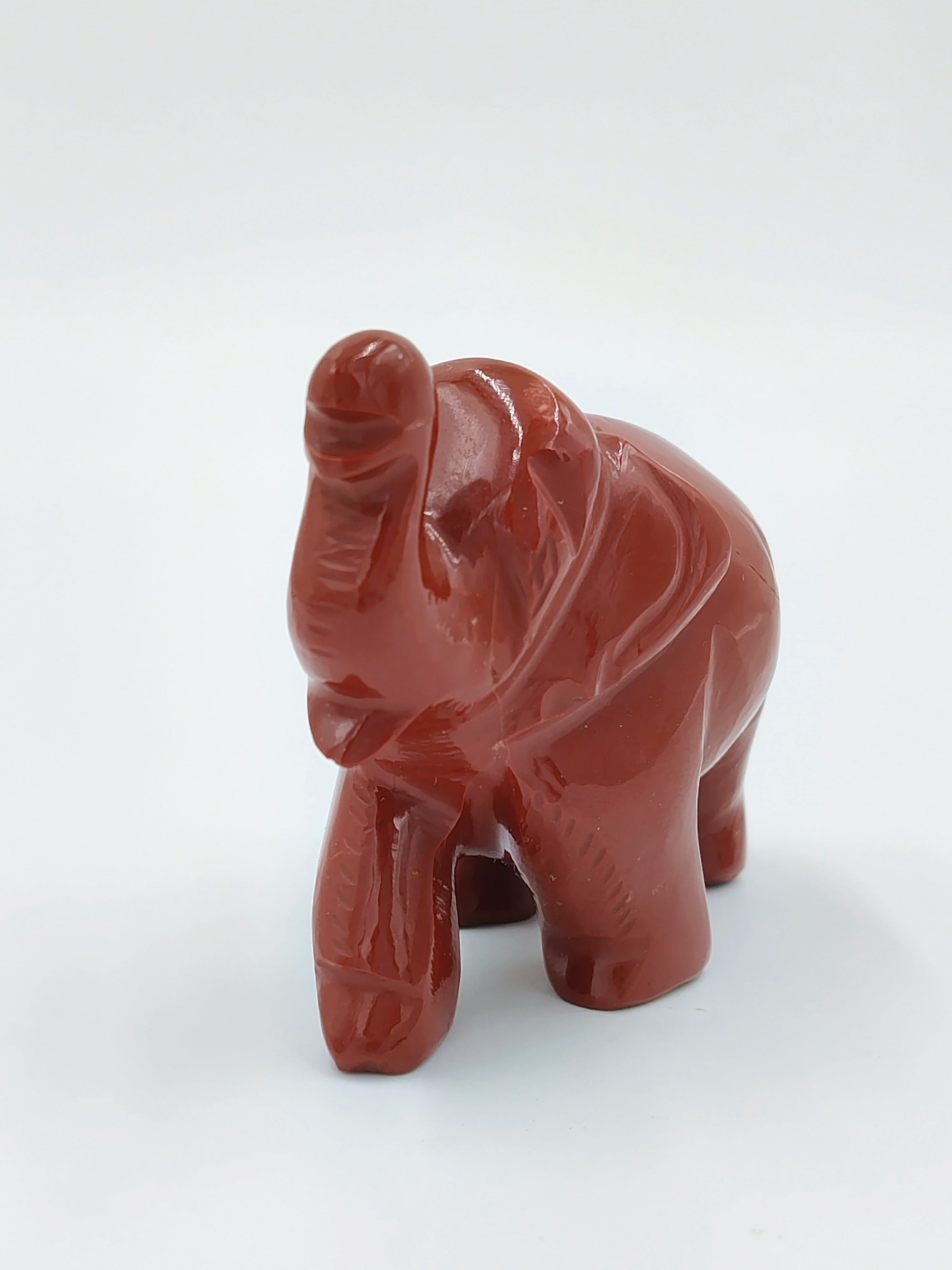 Small polished jasper elephant sculpture with raised trunk, front view