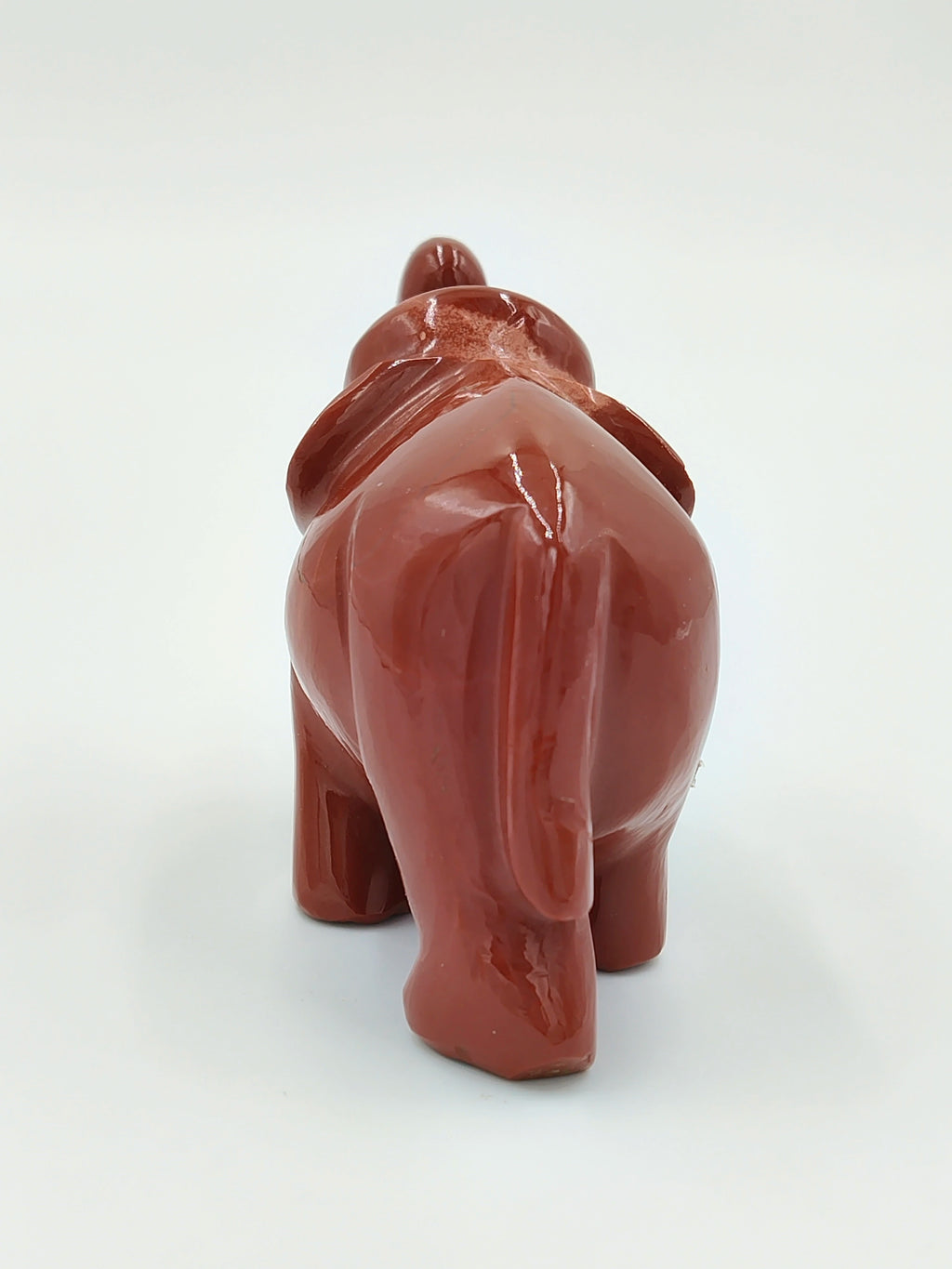 Rear view of a small polished red jasper elephant sculpture