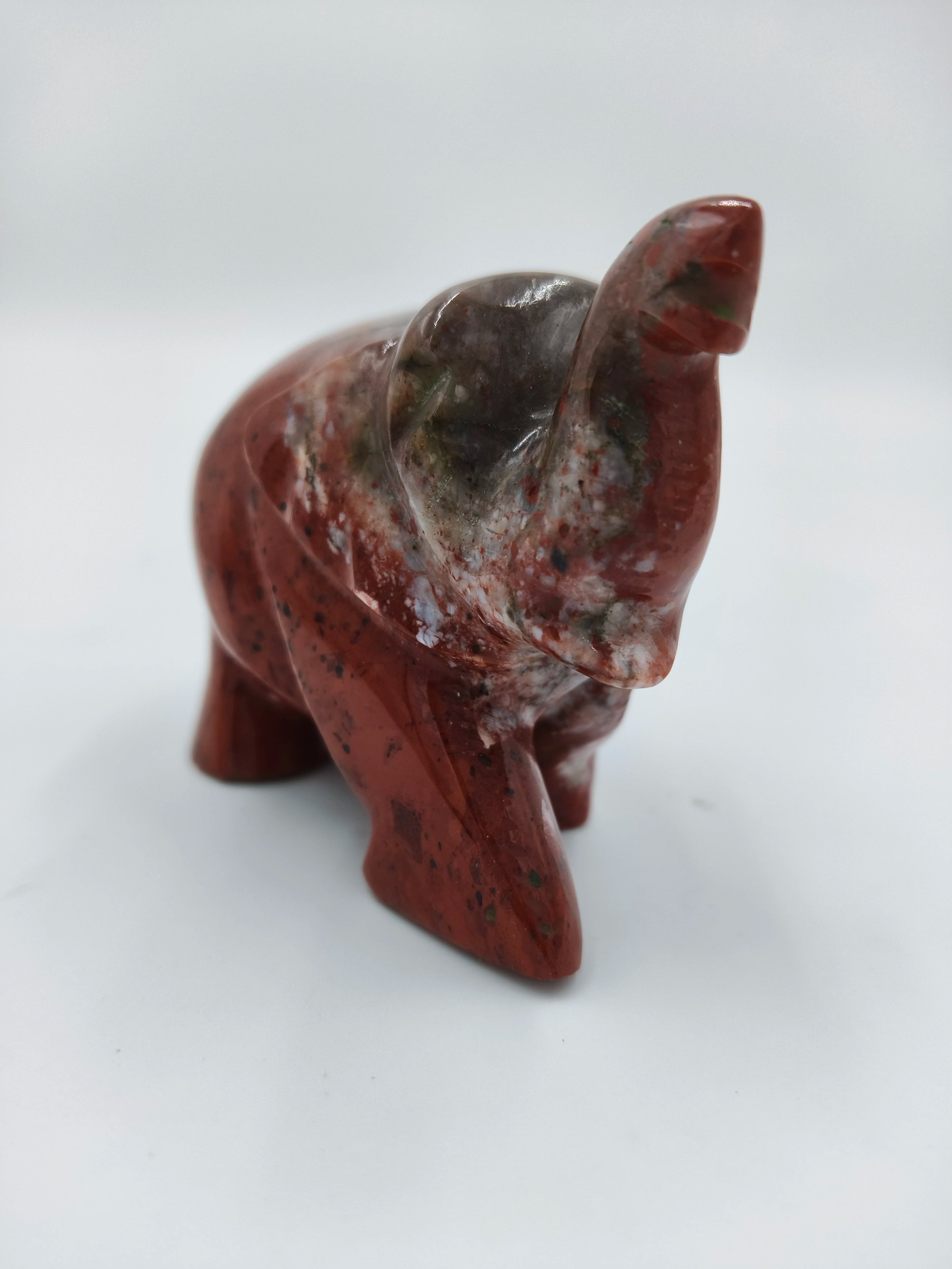 Small jasper stone elephant sculpture with mixed reddish and gray colors