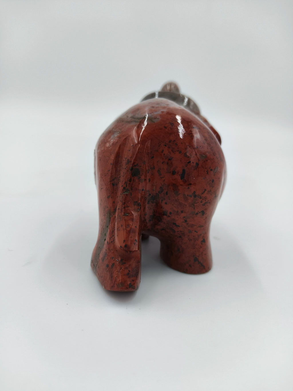 Back view of polished red jasper elephant figurine sculpture