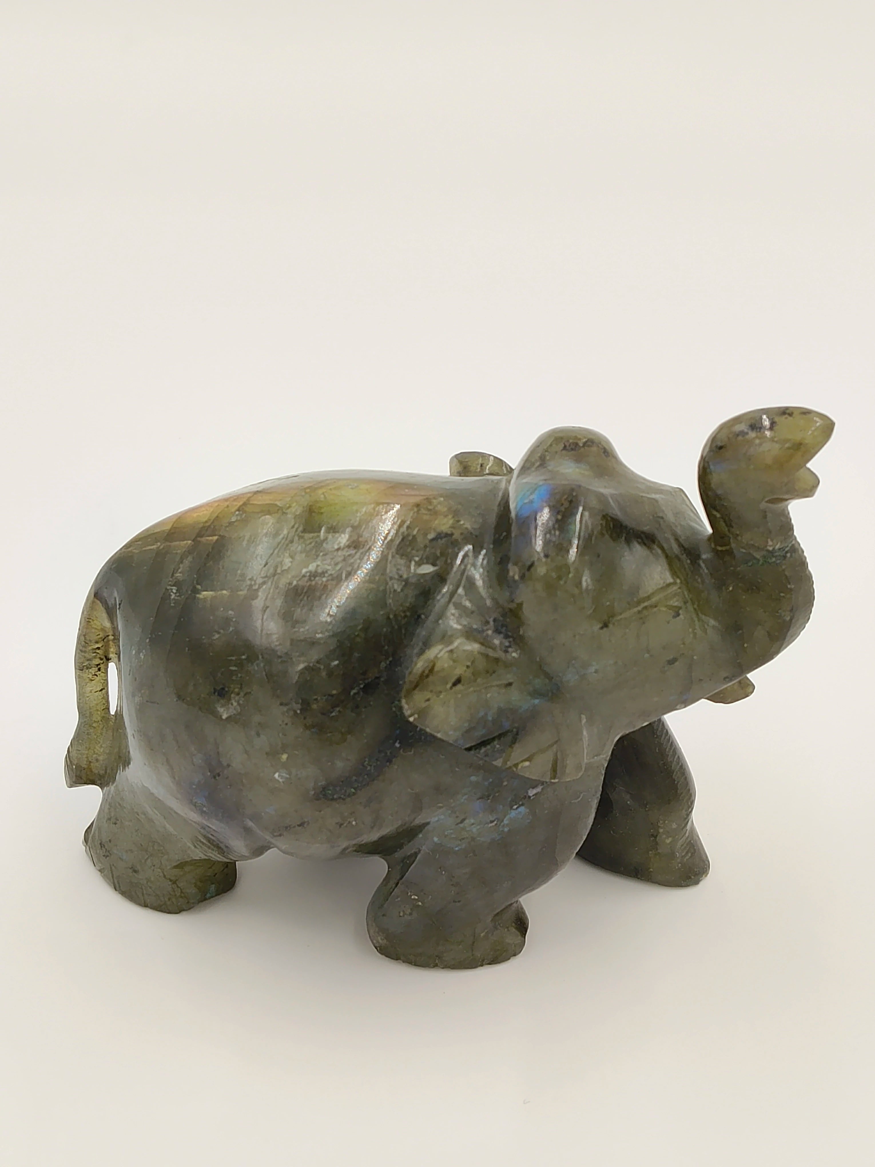 Small labradorite elephant figurine with raised trunk, side view