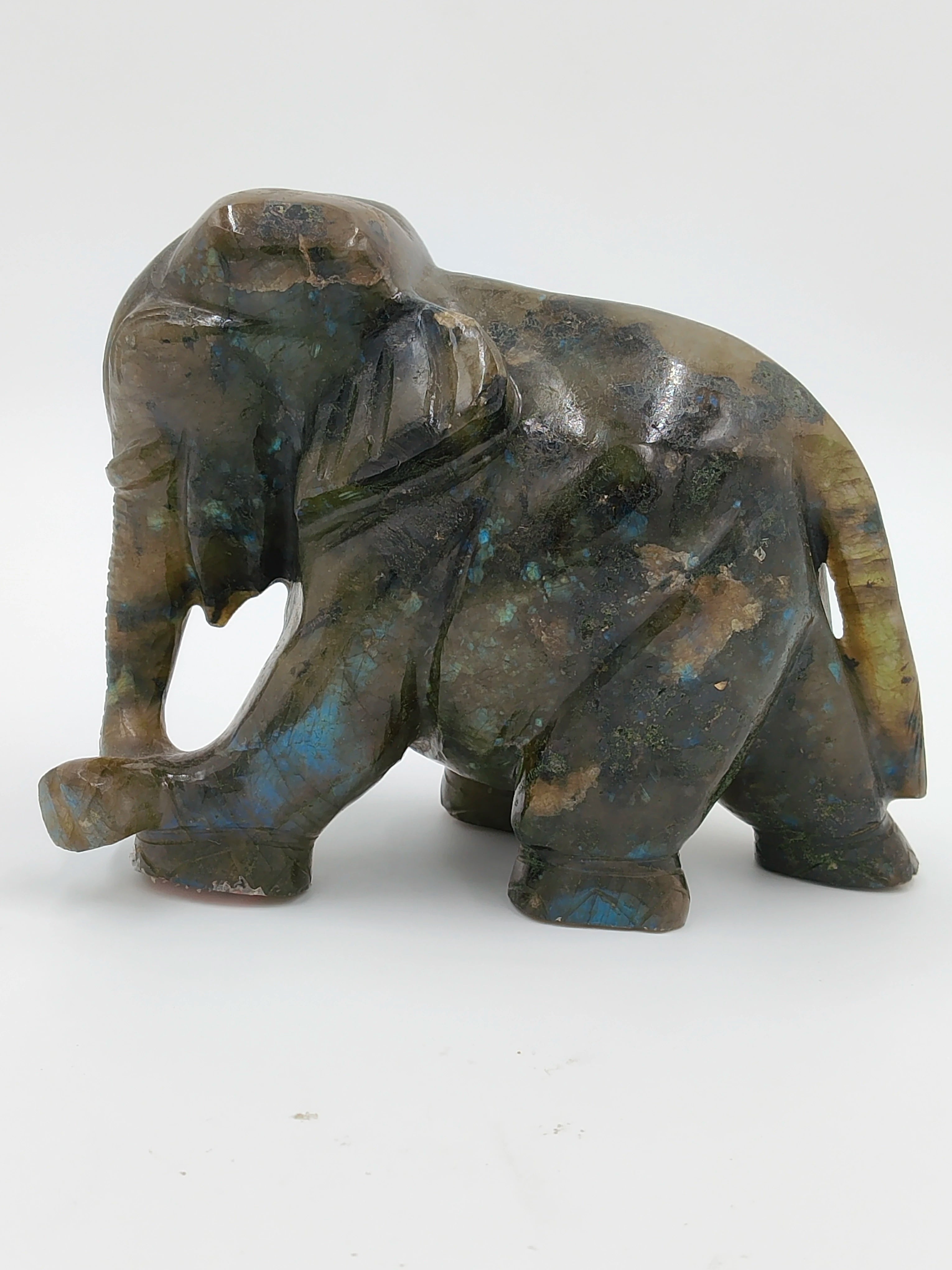 Small labradorite elephant sculpture with iridescent blue and green hues