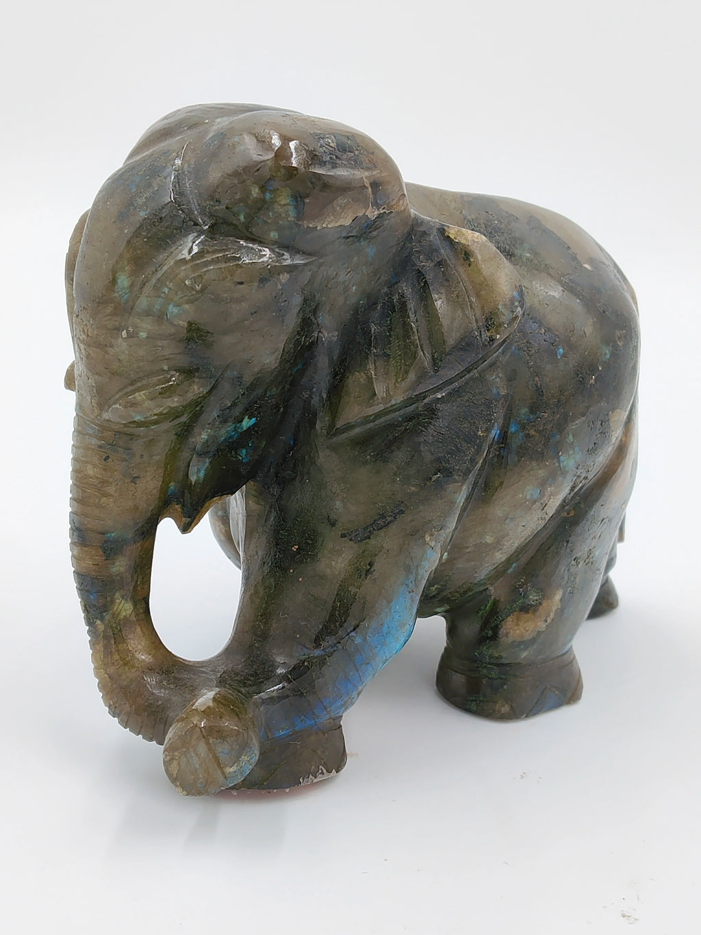 Small labradorite elephant figurine sculpture with blue and green hues