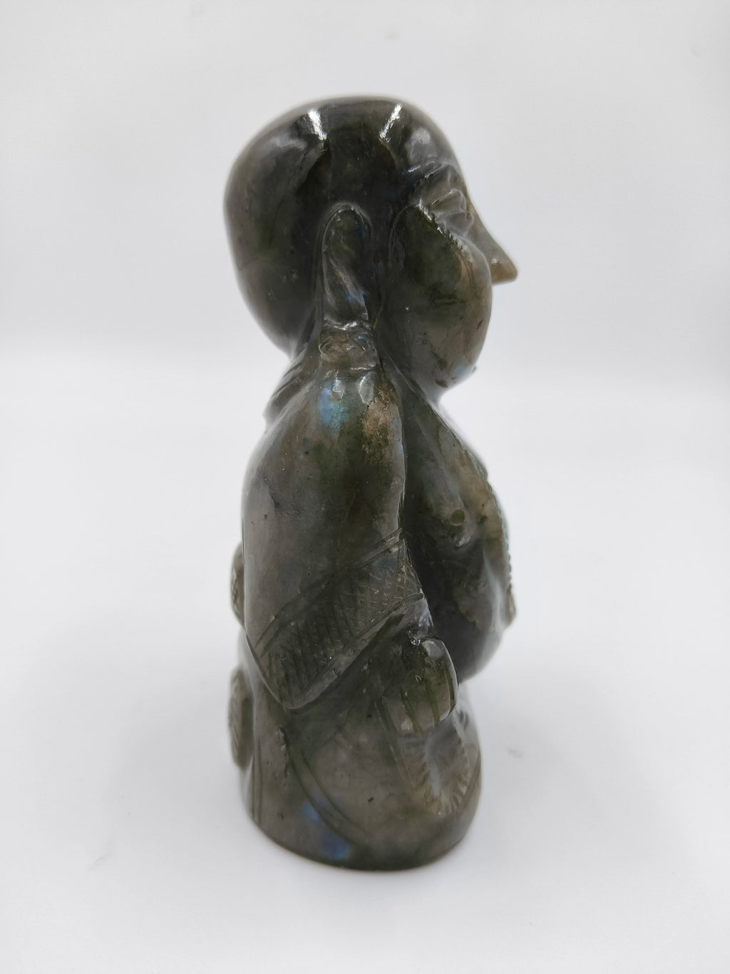 Side view of a small labradorite Laughing Buddha sculpture