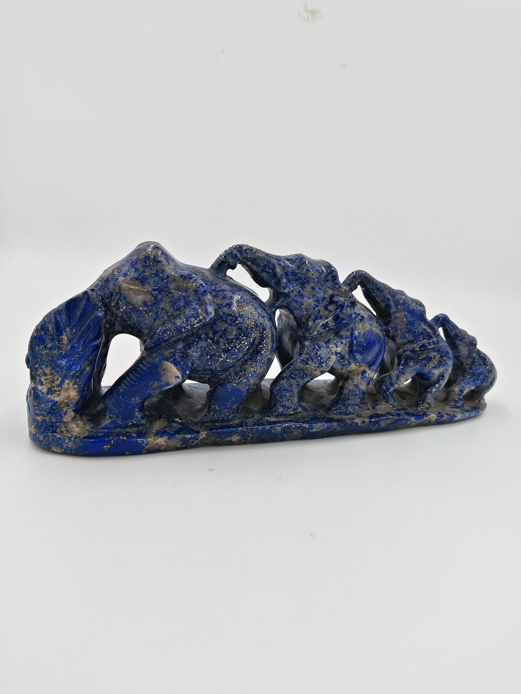 Lapis stone sculpture of a group of elephants in a row