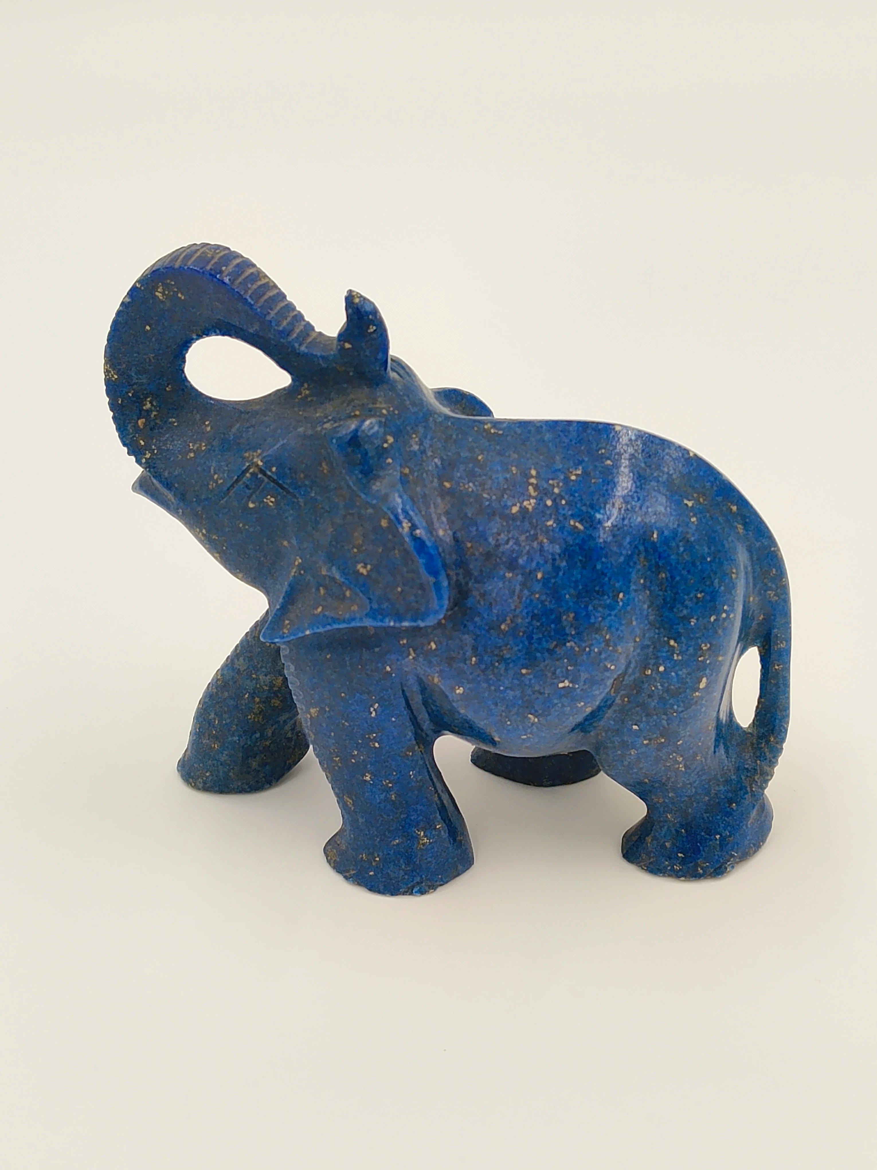 Small blue lapis elephant sculpture with raised trunk, side view