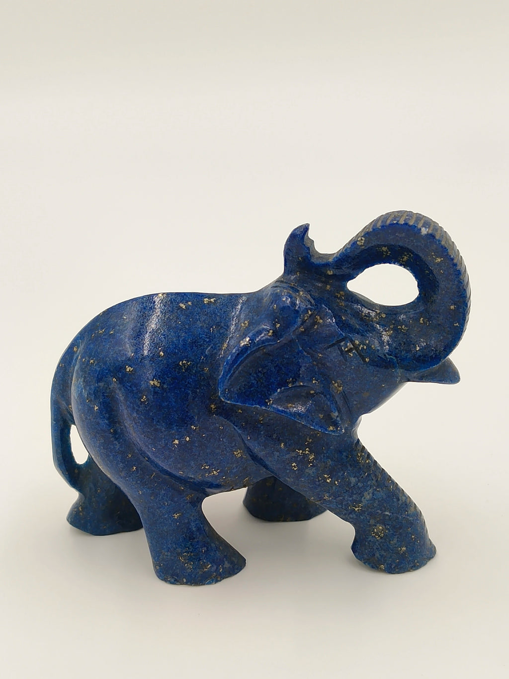Blue lapis elephant sculpture with raised trunk and detailed texture