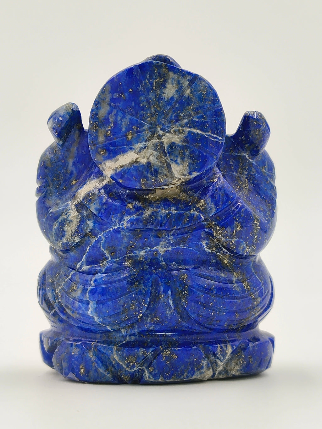 Back view of a small lapis lazuli Ganesh sculpture with intricate details