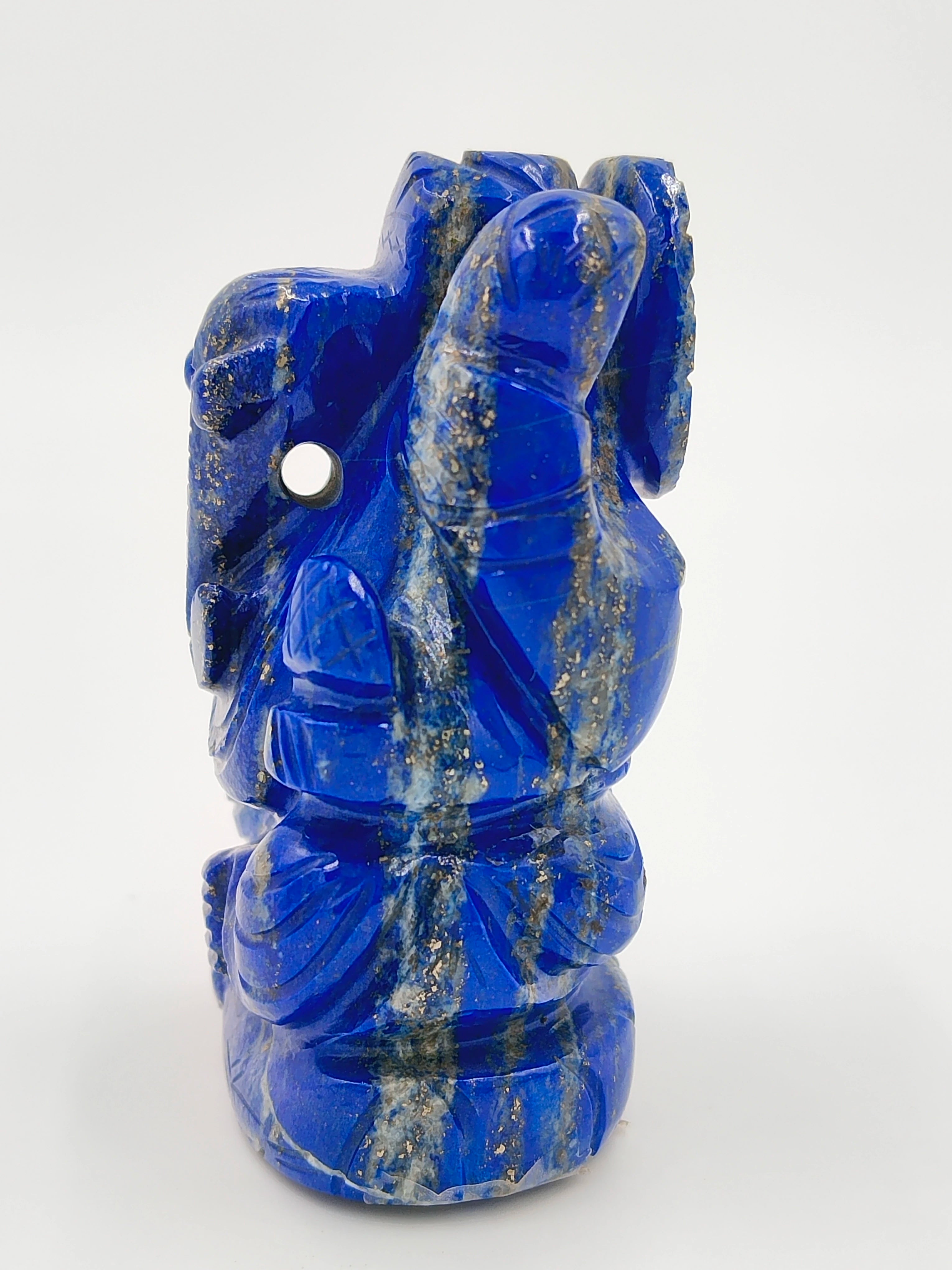 Mini blue lapis Lazuli Ganesh statue with gold flecks standing on a white background