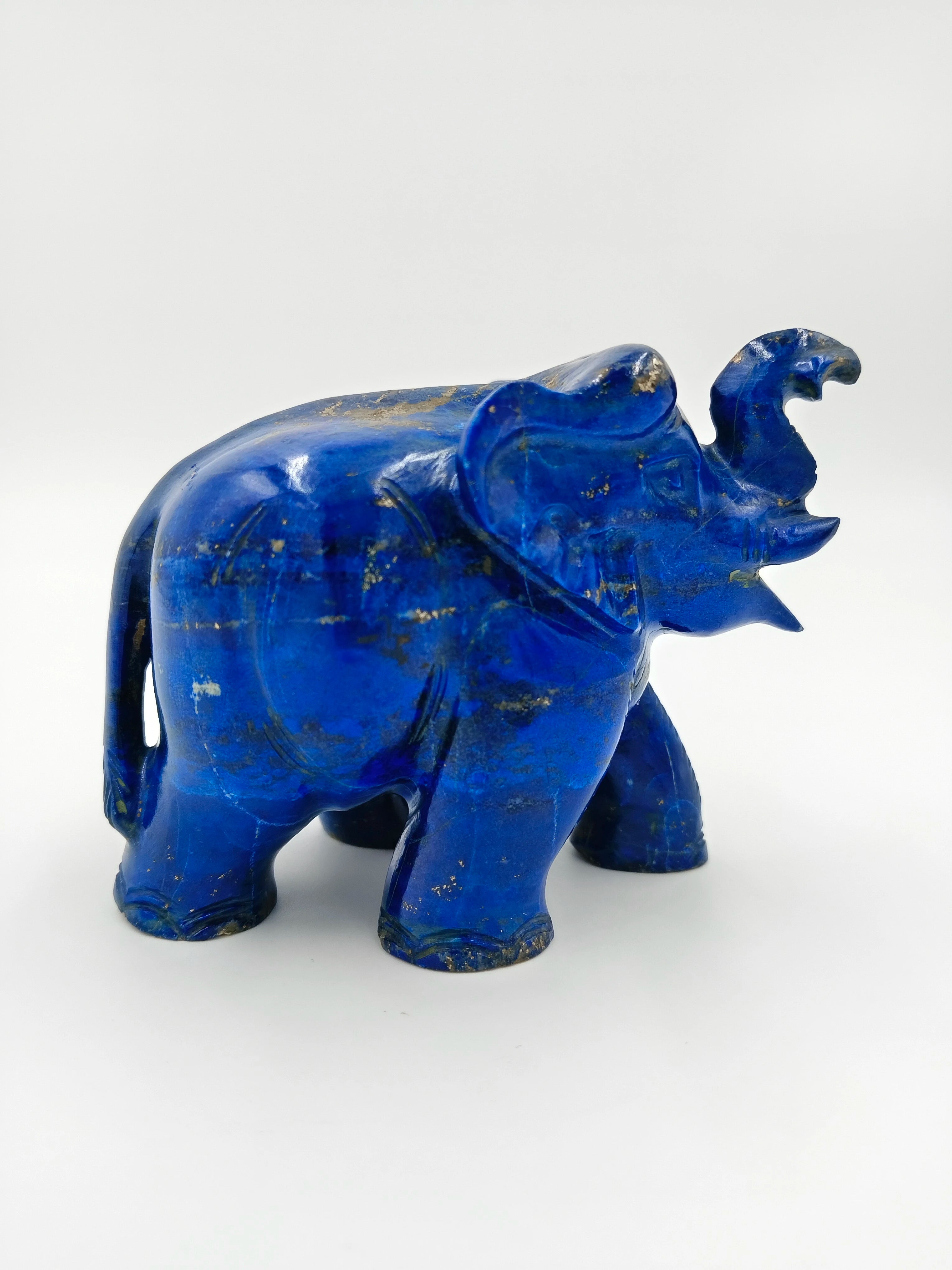Small lapis elephant sculpture with raised trunk and carved details