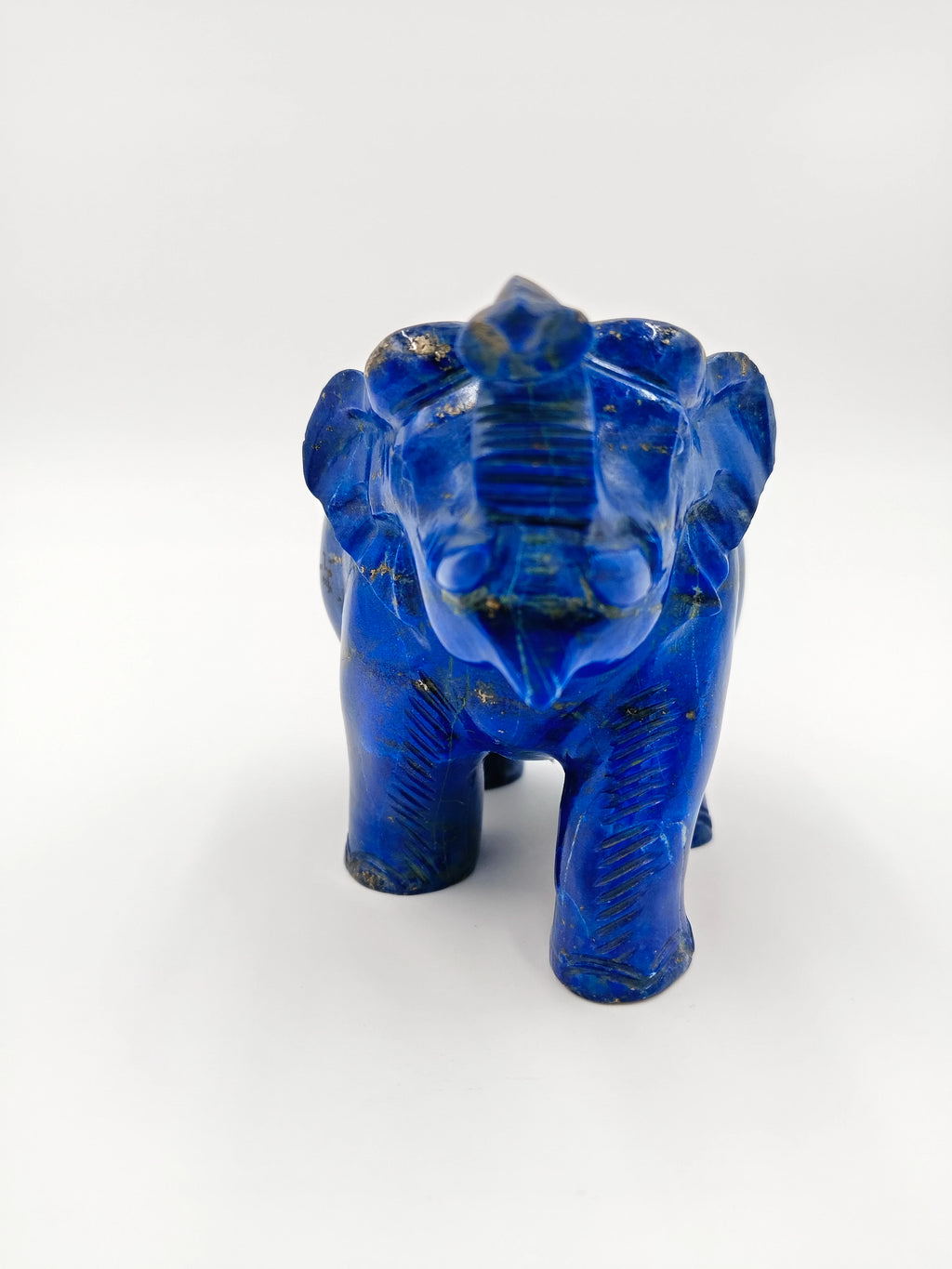 Small blue lapis elephant sculpture front view with carved details