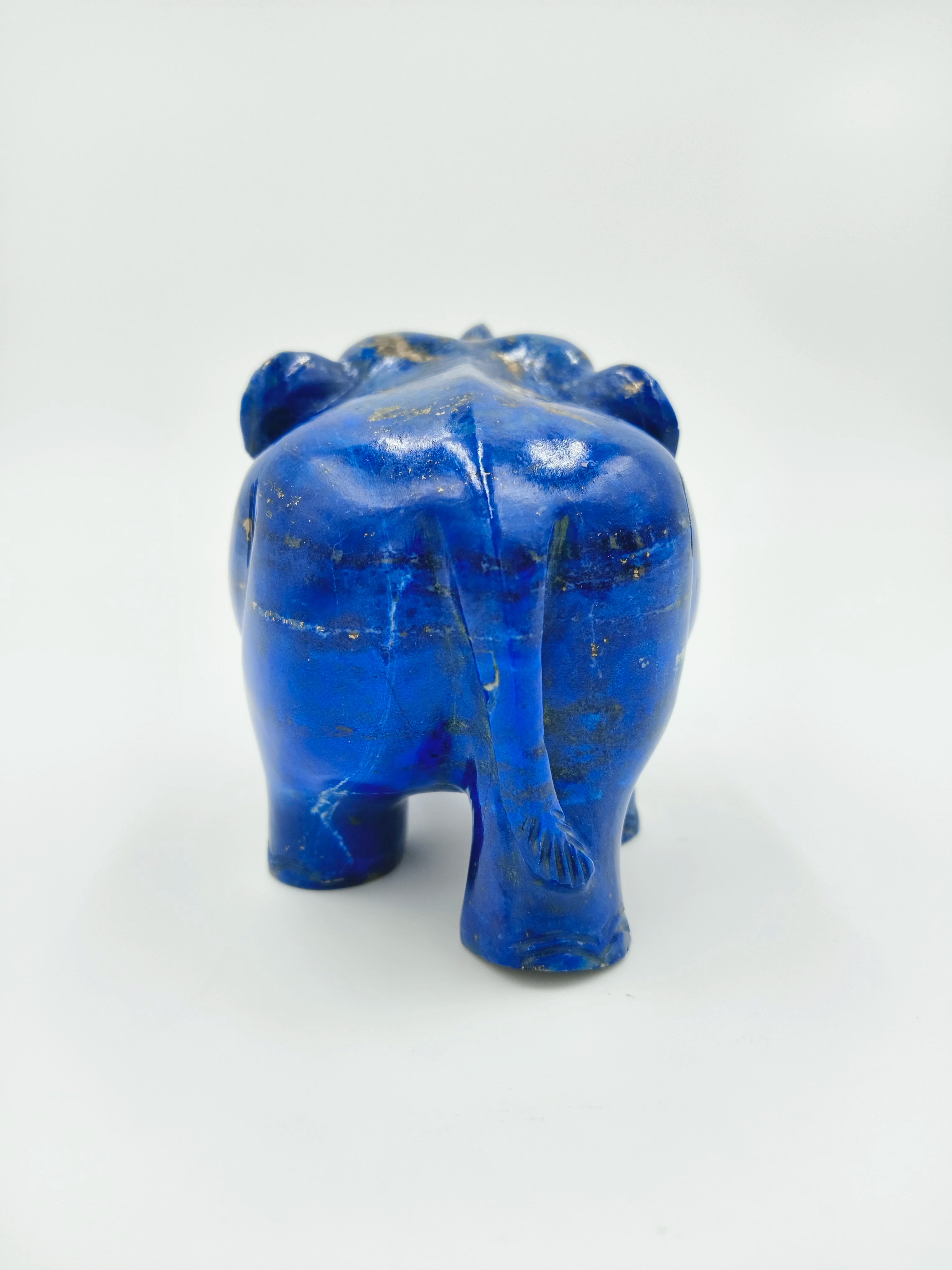 Rear view of small blue lapis elephant sculpture with detailed tail